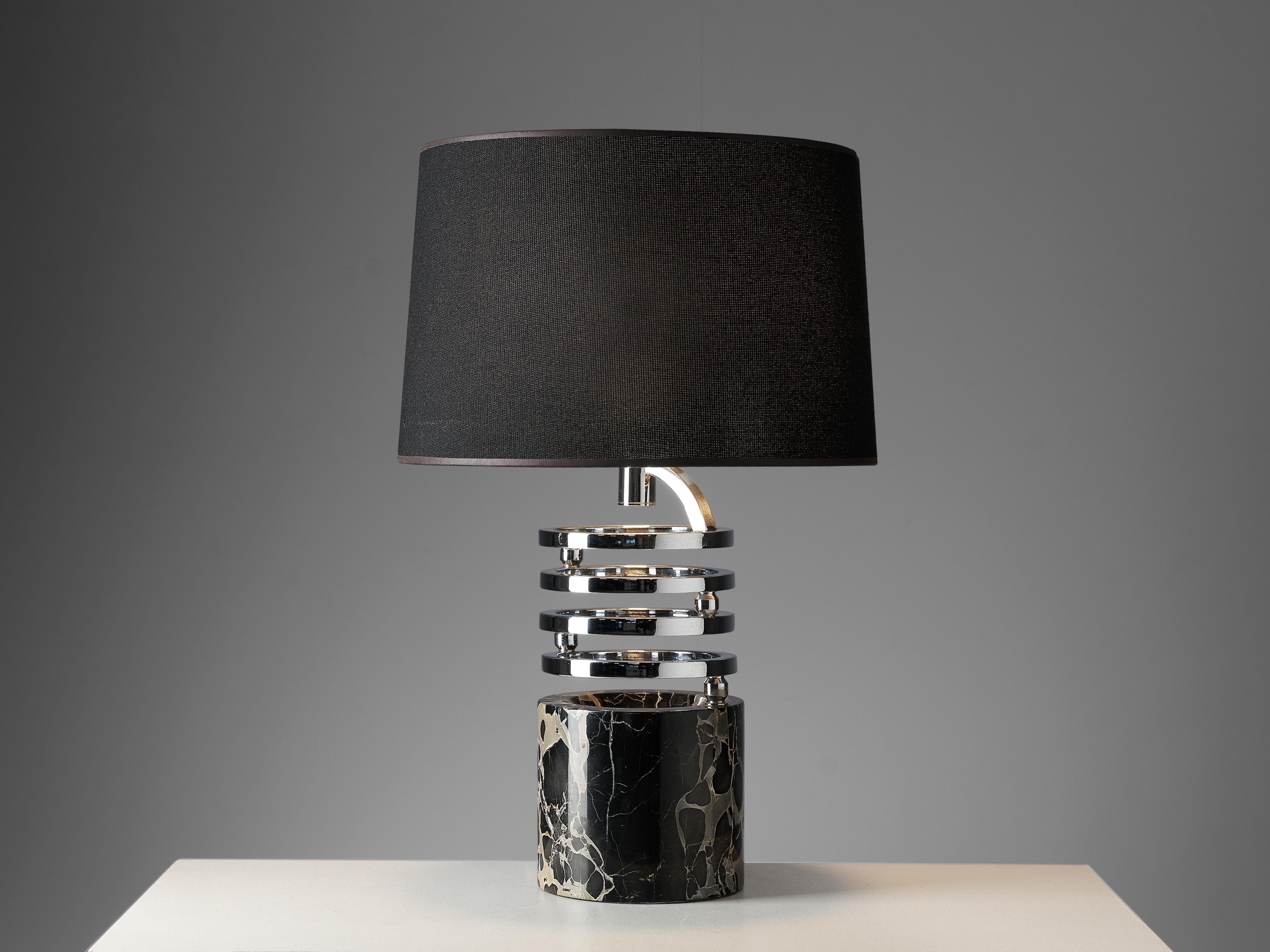 Table lamp, marble, chrome, Italy, 1970s. 

This table lamp of Italian origin features an intricate construction of delicate lines and materials. The four assembled chrome rings can be extended sideways and give this piece a playful appearance. The