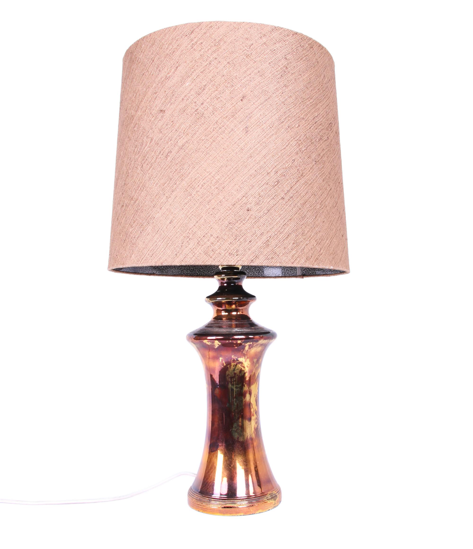 Exceptional handcrafted table lamp by Bitossi, Italy, 1960s. This large lamp in ceramic covered with bronze and gold luster glaze comes with the original silk shade. With this light you make a clear statement in your interior design. A real