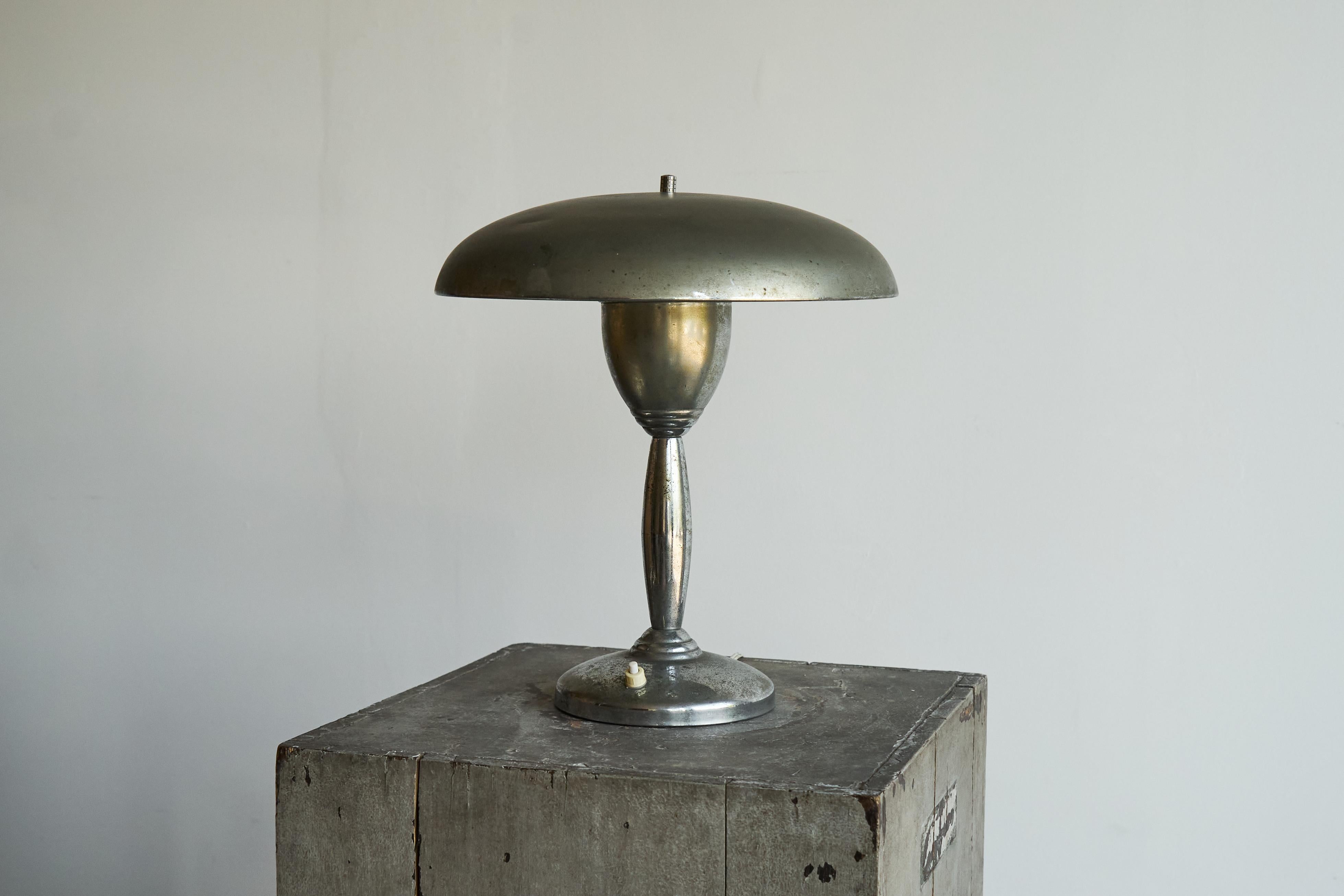 Table Lamp in Patinated and Chrome Plated Brass 1950s.

A wonderful mid century table lamp in chrome plated brass with a very nice patina. Timeless and elegant mushroom style design, with good proportions. The patina adds to the charm and shows this