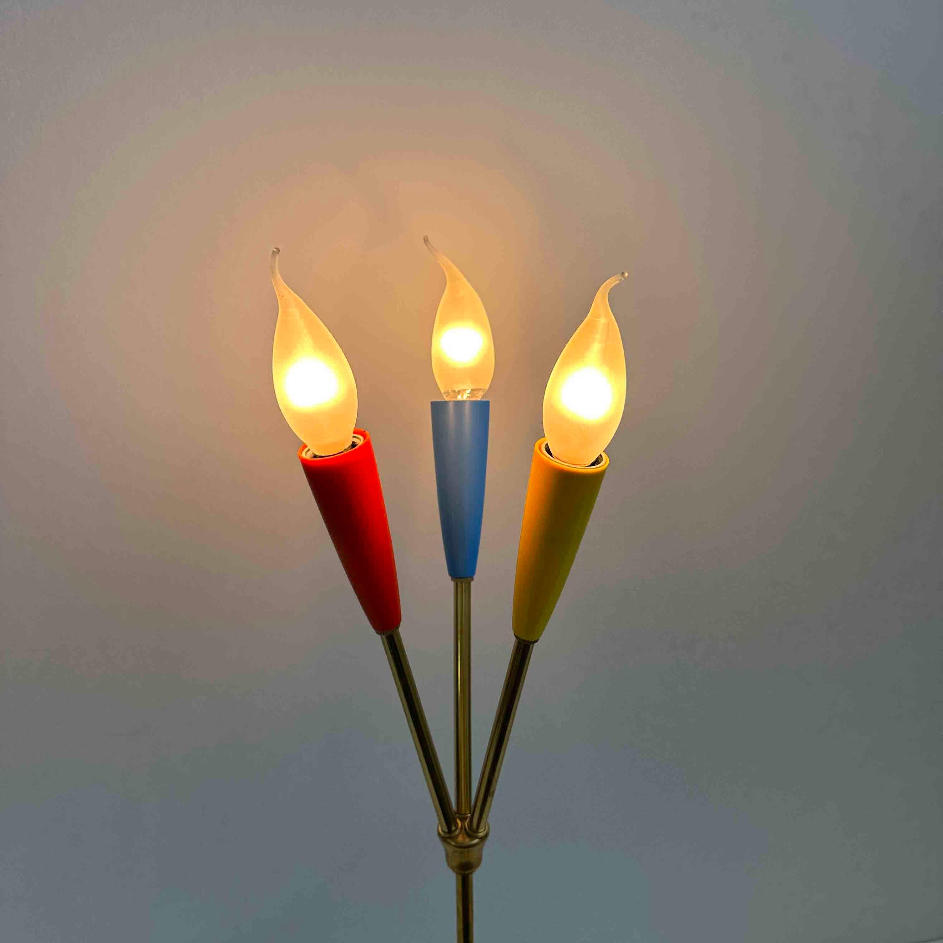 Beautiful table lamp with influences from Stilnovo and the Sputnik style. The lamp is equipped with original caps in red, blue, and yellow. The wiring has been checked. 

Germany, 1960s

Designer/Manufacturer: Unknown

In beautiful condition: