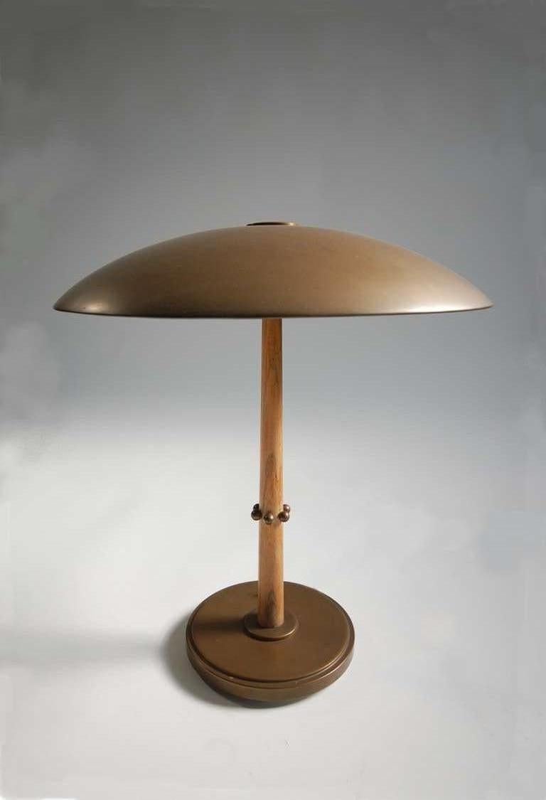 Table lamp in brass and oak, Sweden, circa 1955. Very much in the style / aesthetic of Paavo Tynell. Brass elements have a beautiful, warm patina.

