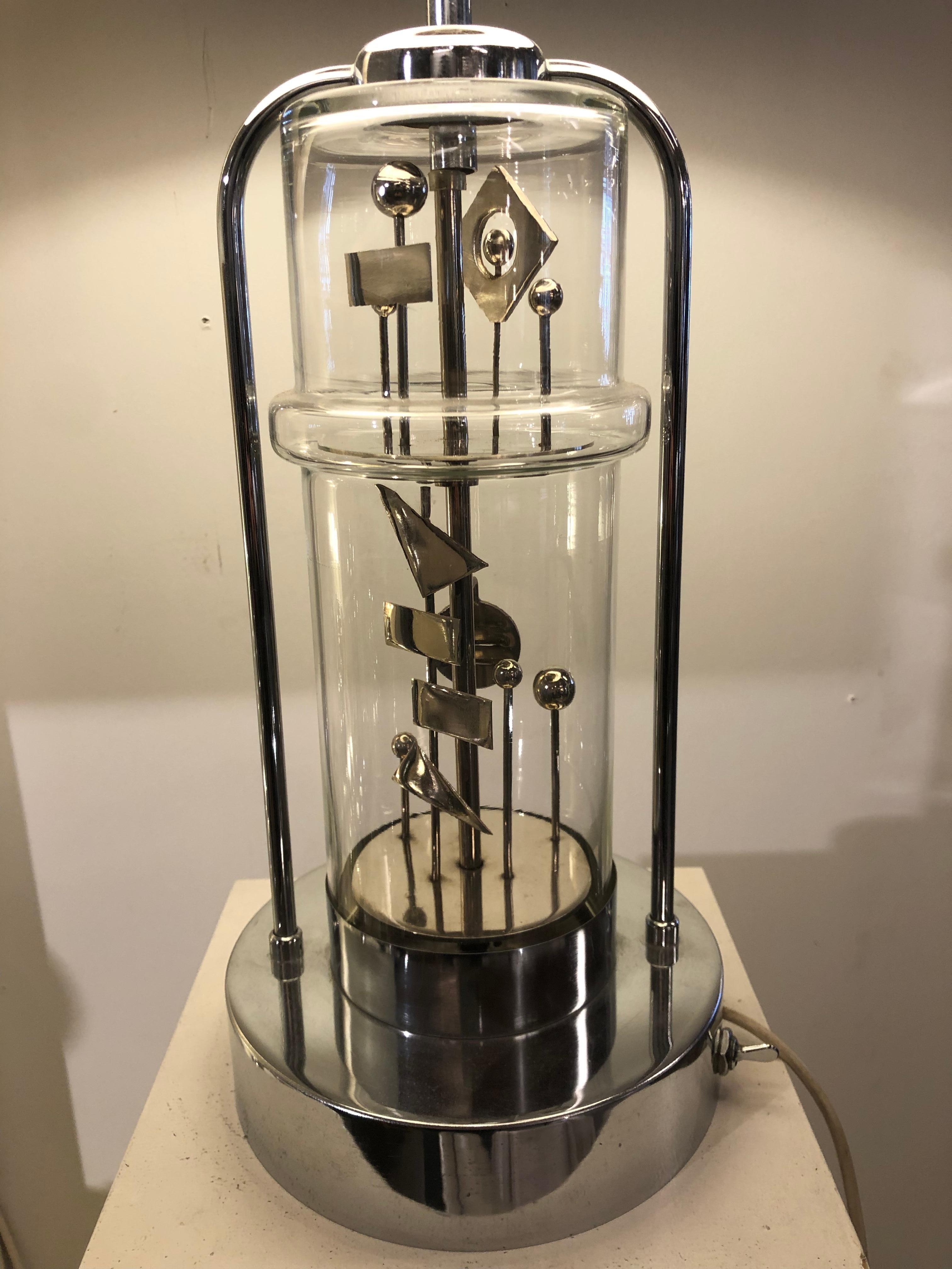 Very rare table lamp with a Mobil inside the glass that 
Can be activated with a separate switch than the light. Unknown maker but dated from the seventies and probably French.
  