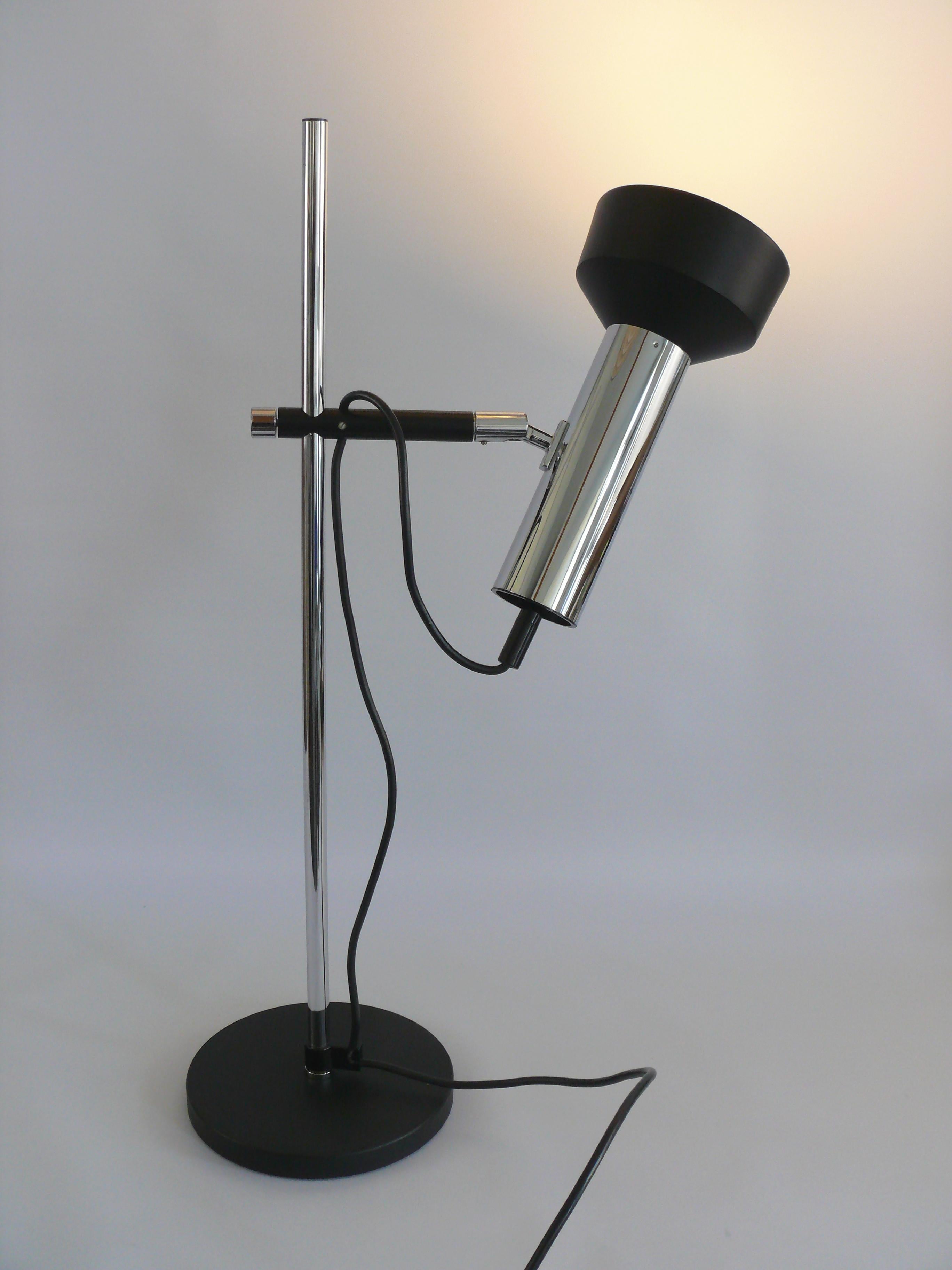 Solid bar lamp from the 1960s by the company Staff Leuchten, type L 401. The company Staff from Lemgo stood for high-quality, modern lamp design. The lamp shows the typical design of the time with contrasts between chromed areas and matt lacquered