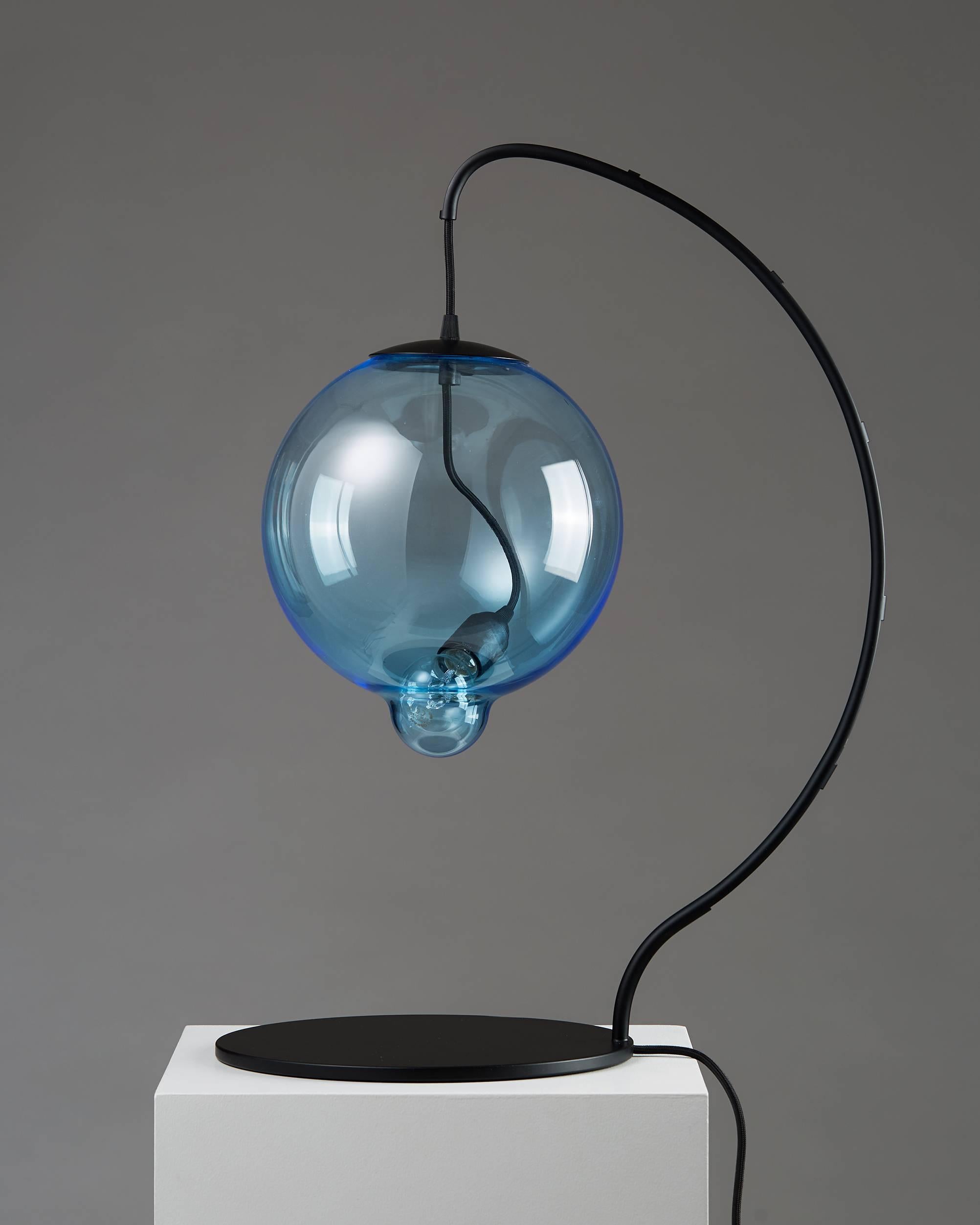 Black-lacquered steel, blue-tinted glass.

Measures: H: 67 cm/ 26 1/4''
D: 46 cm/ 18''
W: 30 cm/ 11 3/4''.