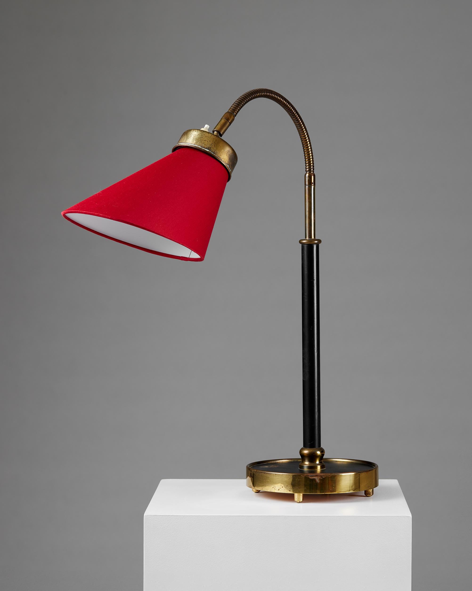 Table lamp model 2434 designed by Josef Frank for Svenskt Tenn,
Sweden, 1939.

Polished and lacquered brass, a leather-clad stem with a textile shade.

Stamped.

Josef Frank was a true European, he was also a pioneer of what would become classic