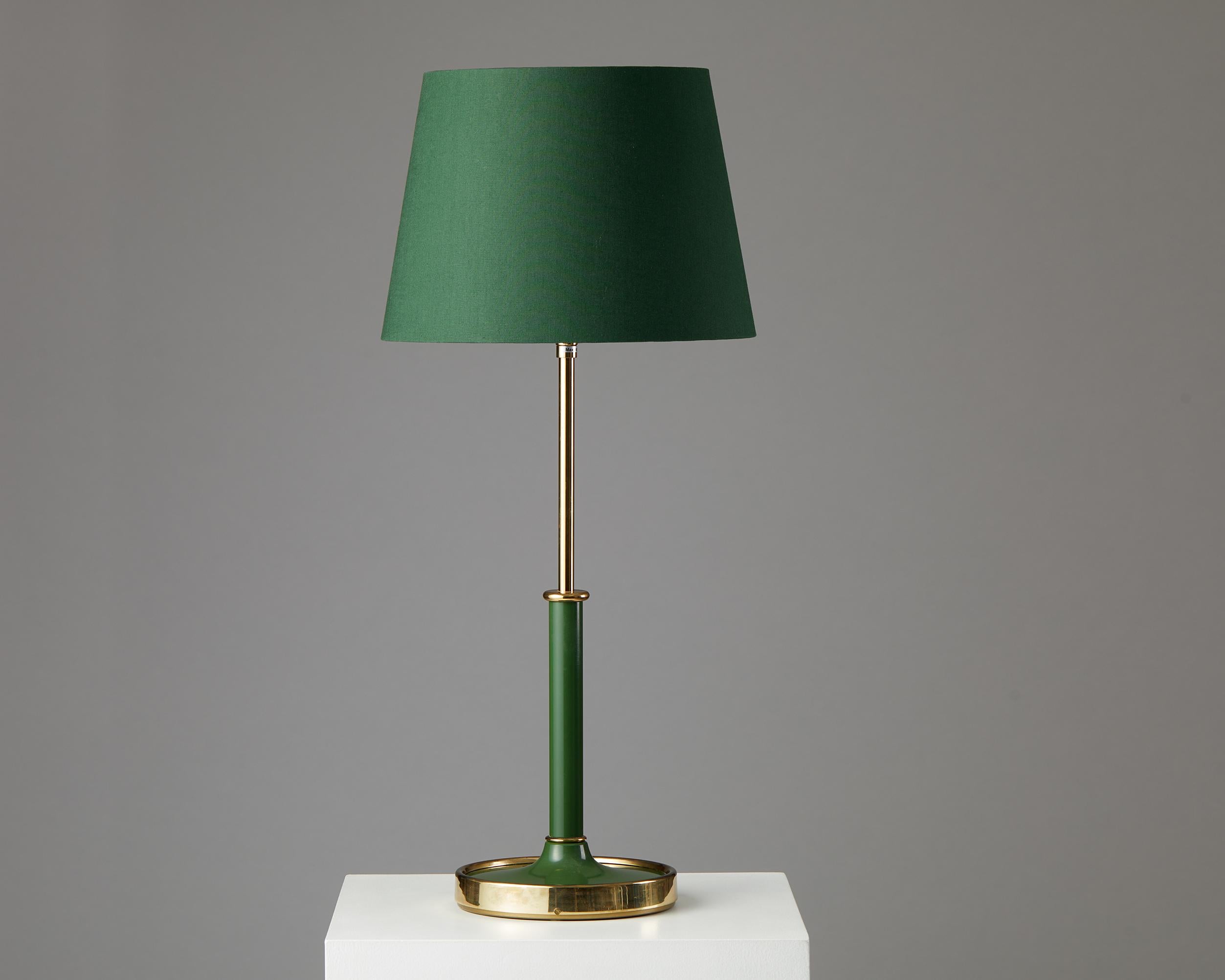 Table lamp model 2466 designed by Josef Frank for Svenskt Tenn,
Sweden, 1950s.
Brass, lacquered metal and fabric shade.

This delightful lacquered brass table lamp in a warm green tone is incredibly well proportioned. Josef Frank created three