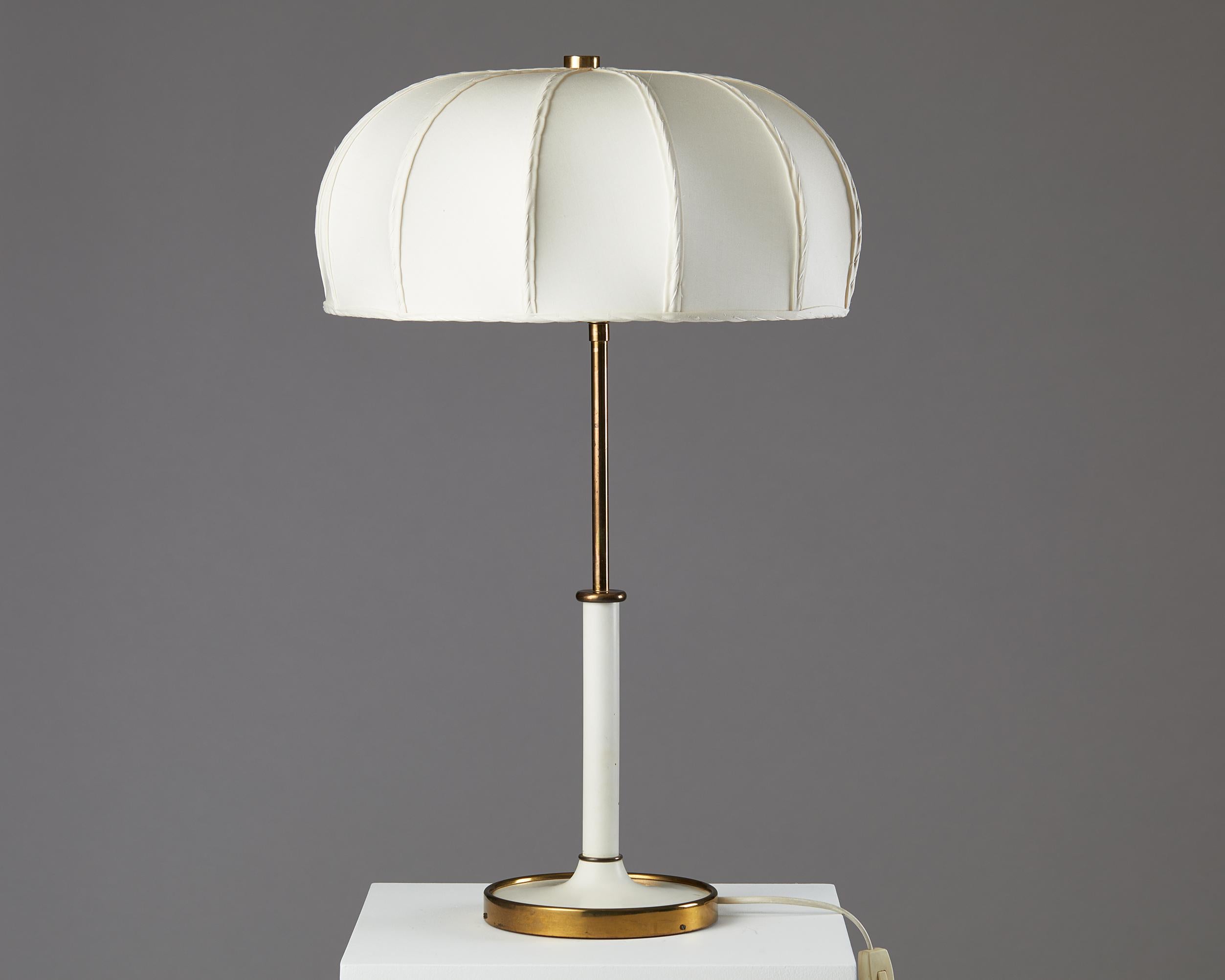 Table lamp model 2466 designed by Josef Frank for Svenskt Tenn,
Sweden. 1950s.
Brass and silk shade.

An understated and timeless design, the model 2466 by Josef Frank is found in both a table lamp and floor lamp silhouette. The brass base