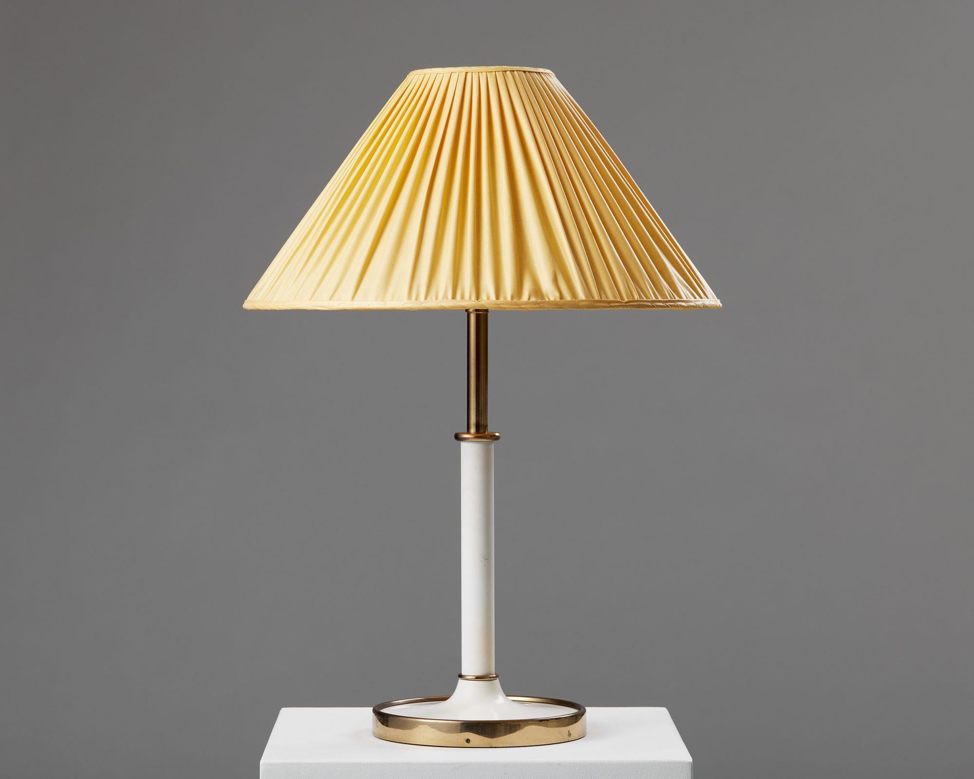 Table lamp model 2466 designed by Josef Frank for Svenskt Tenn,
Sweden, 1950s.

Brass with fabric shade.

Stamped.

An understated and timeless design, the model 2466 by Josef Frank is found in both a table lamp and floor lamp silhouette. The
