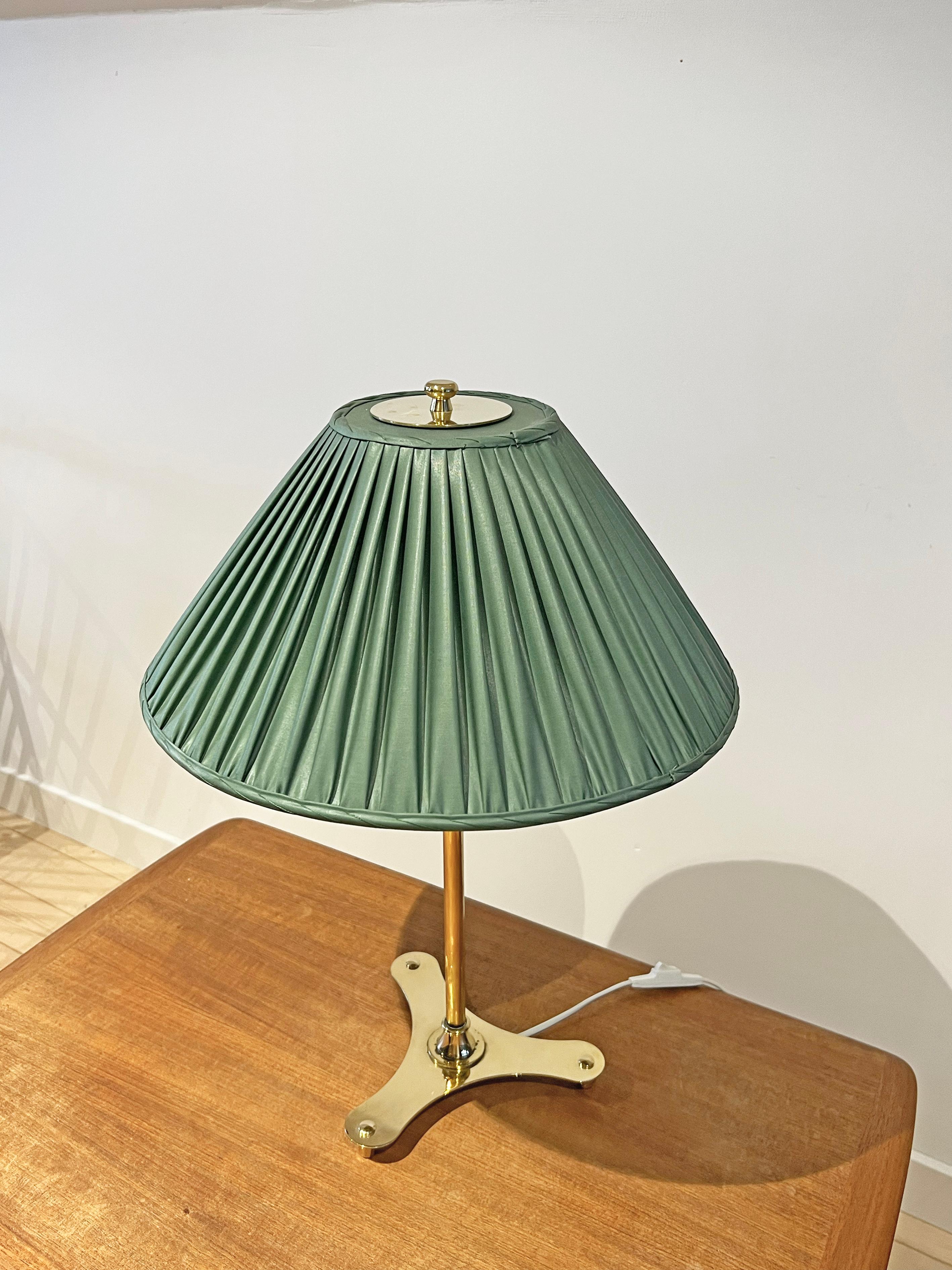 Table lamp model 2467/2 designed by Josef Frank for Firma Svenskt Tenn, Sweden, 1950s. Brass with fabric shade (the shade is most likely original). 
Signed with maker's mark. 
This model is featured in Svenskt Tenn's catalog from the 1950's as