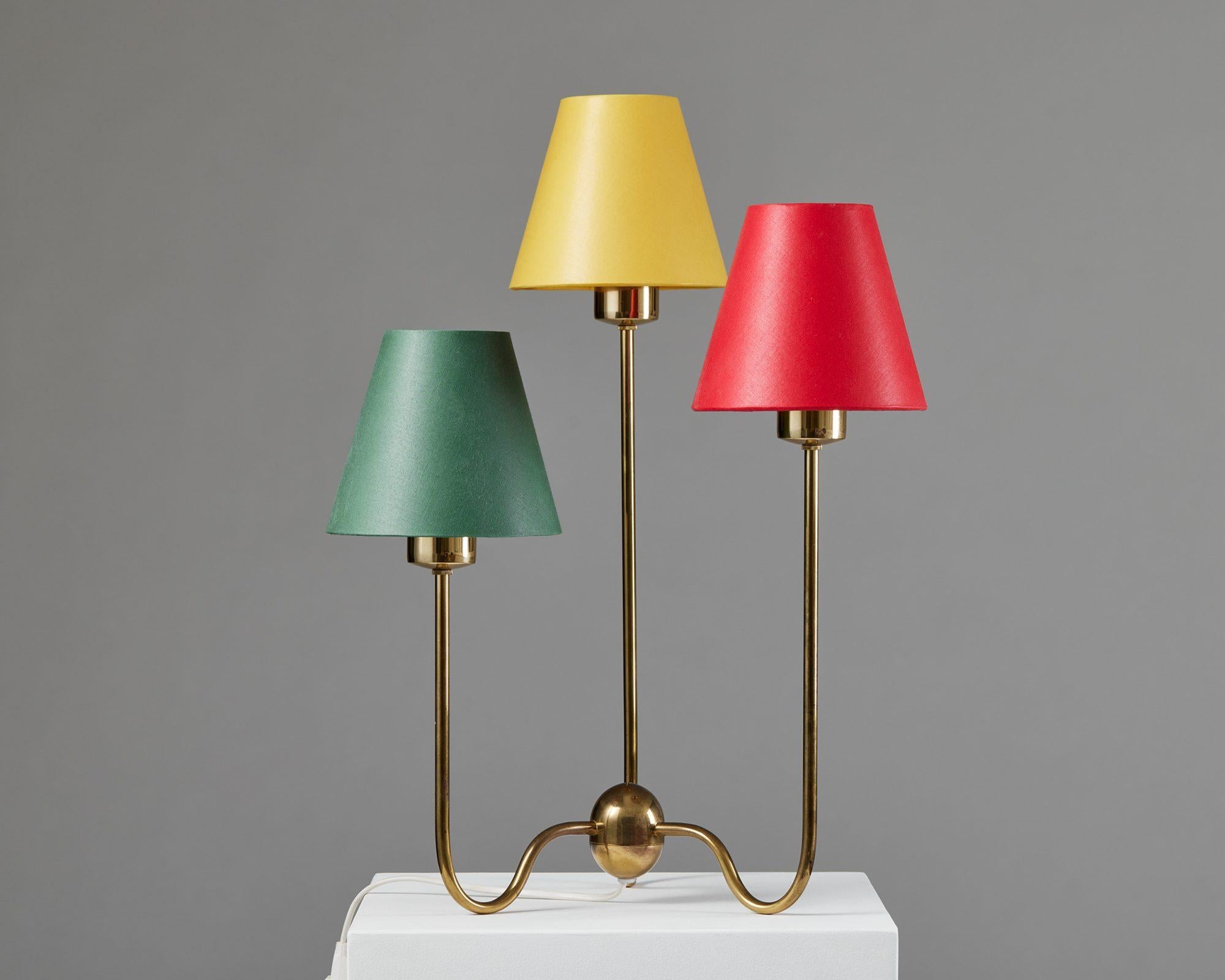 Table lamp model 2468 designed by Josef Frank for Svenskt Tenn,
Sweden, 1950s.

Brass with cotton shades.

Stamped.

Model 2468 is a delightful brass table lamp with three small shades in green, yellow, and red. The lamp has an elegant brass