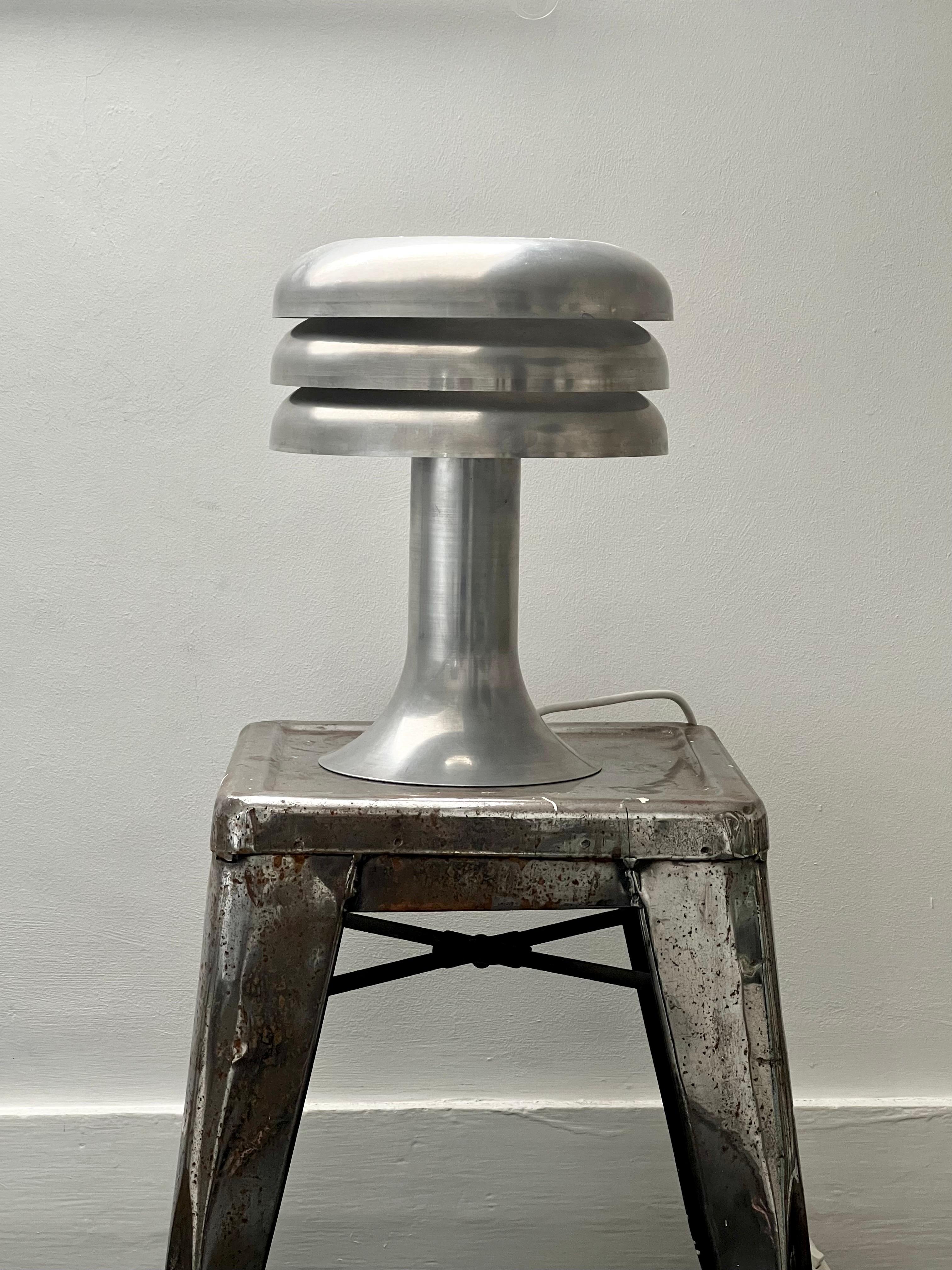 Table lamp model BN-25 by Hans Agne Jakobsson, Sweden, 1960s. 

Spun aluminium lamp with integrated three-tiered shade (white inside) giving nice ambient light. The lamp is in good vintage condition. It was refinished some years ago; it is