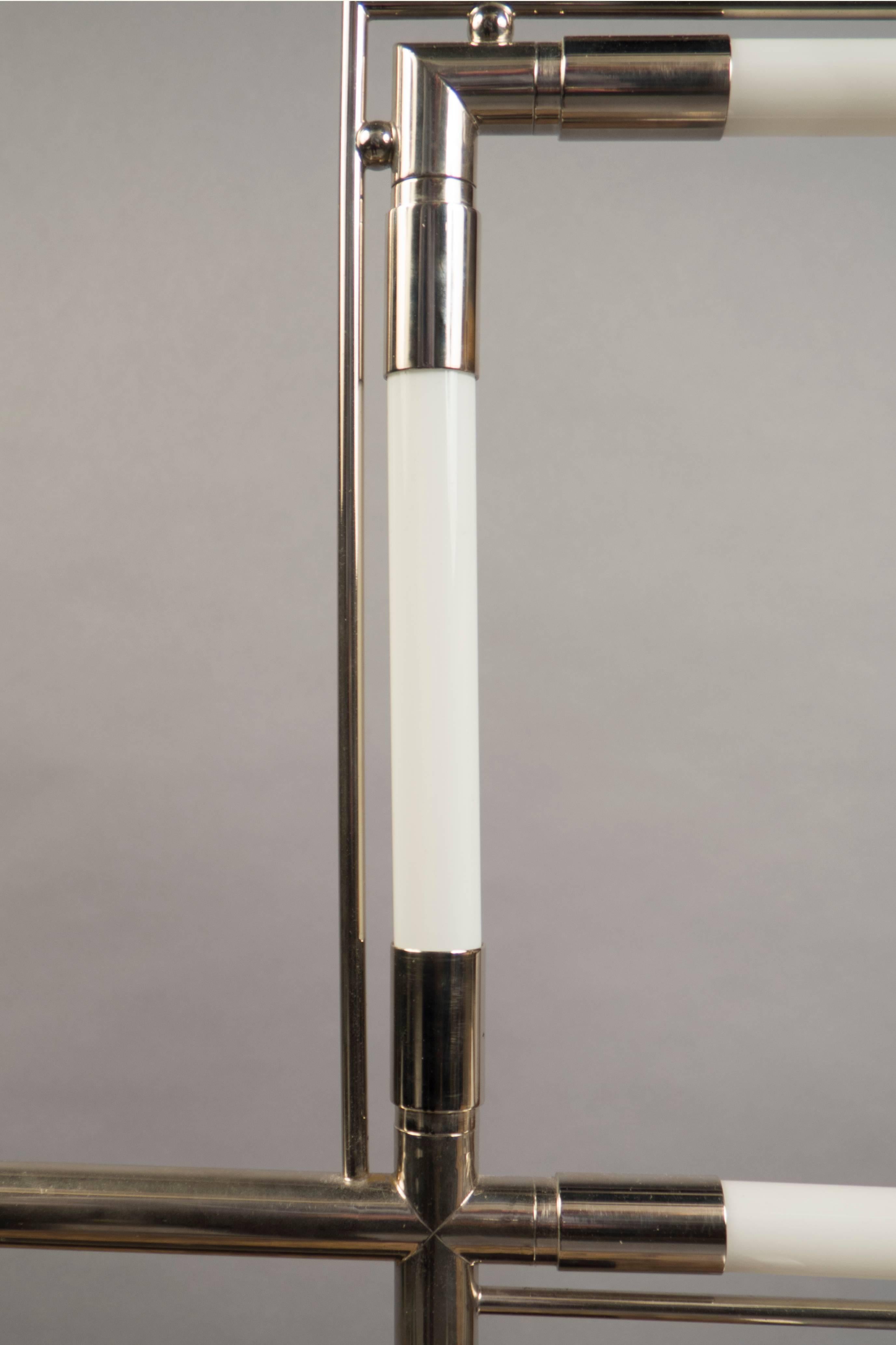 Chrome and glass table lamp, formed of two squares. Model “Quatro”. Originally designed in 1928.
   