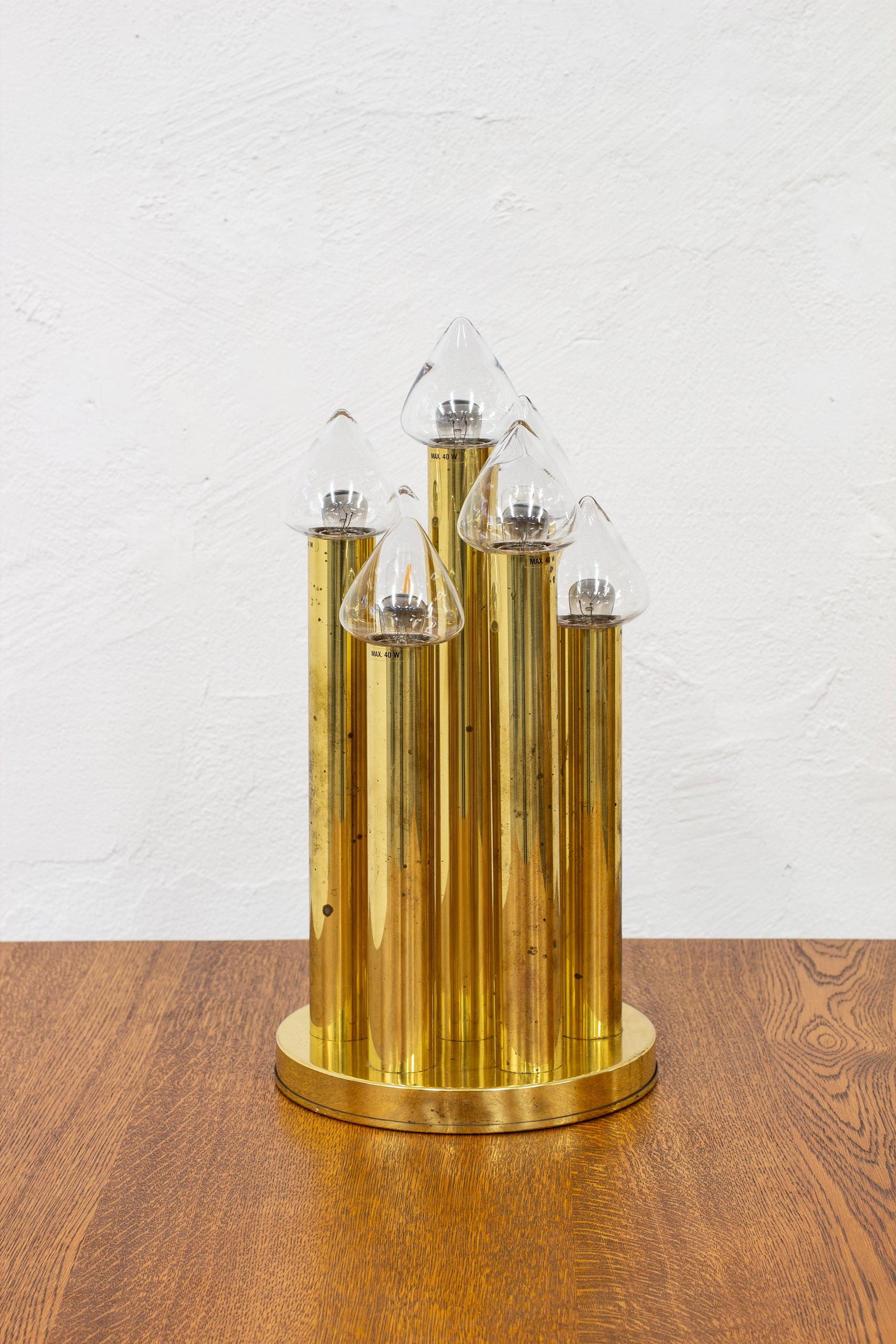 Very rare table lamp model B 231 designed by Hans-Agne Jakobsson. Produced by his own company during the 1960s. Made from seven polished brass pillars standing on a round brass base. Seven hand blown clear glass shades with conical shape. Hans-Agne