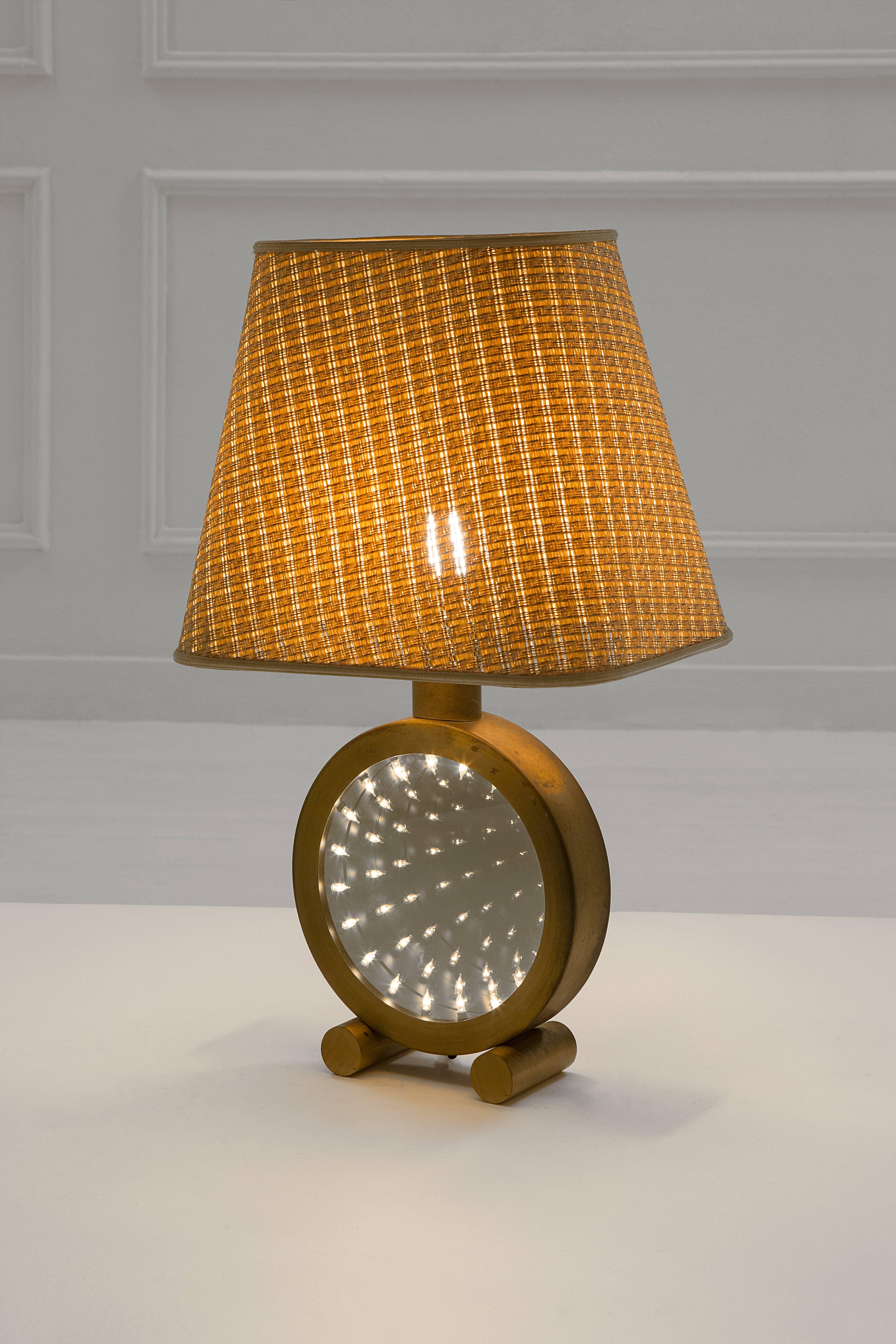 Table lamp,
polished brass and glass,
circa 1970, Italy.
Measures: Height 60 cm, diameter 35 cm.