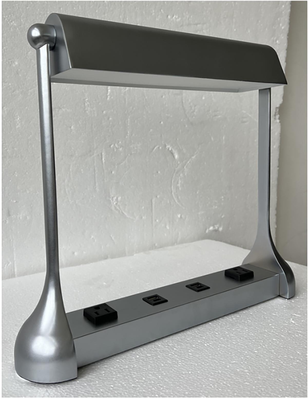 Introducing a custom table lamp that elegantly blends the classic charm of traditional reading lamps found in libraries and banks with modern functionality. Featuring integrated charging sockets for USB, USB-C, and standard power plugs, the table