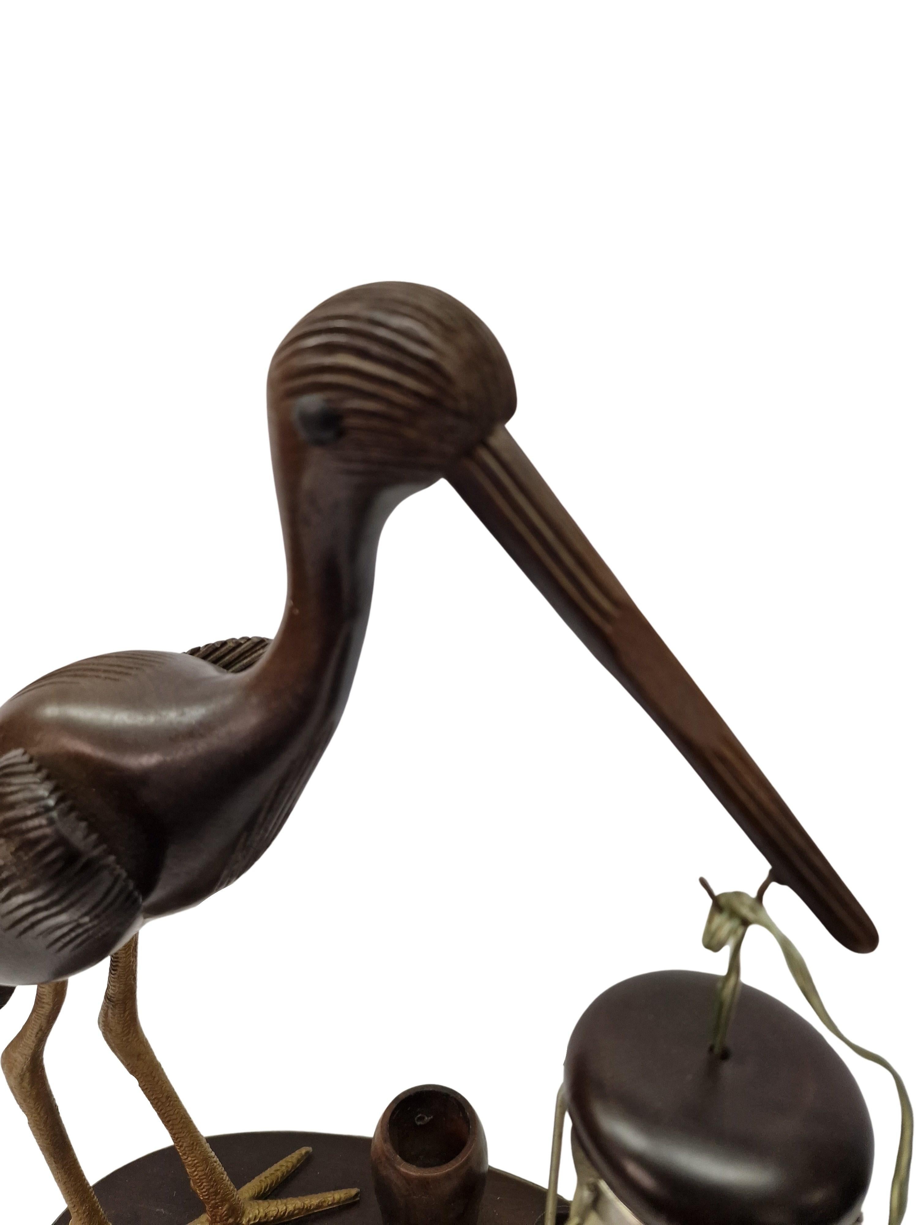 Wonderful table lamp, smoker set, designed by Aldo Tura, made in the 1940s in Italy. 

The base is an oval plate, carrying a spectacularly hand carved heron bird of beech wood which was stained. The bird has a lantern in his beak. On the base is an