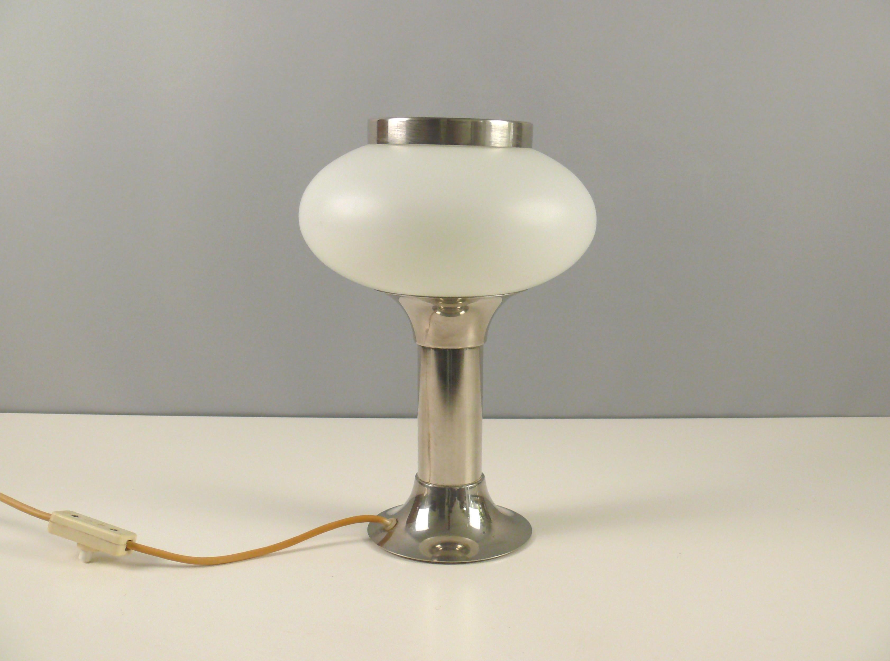 Rare and elegant table lamp made of opal glass with a chrome-plated metal base by VEB Narva Leuchtenbau Lengenfeld, GDR - design Classic of the Space Age era, 1970s. A special feature of this lamp is the metal ring loosely placed on top of the glass