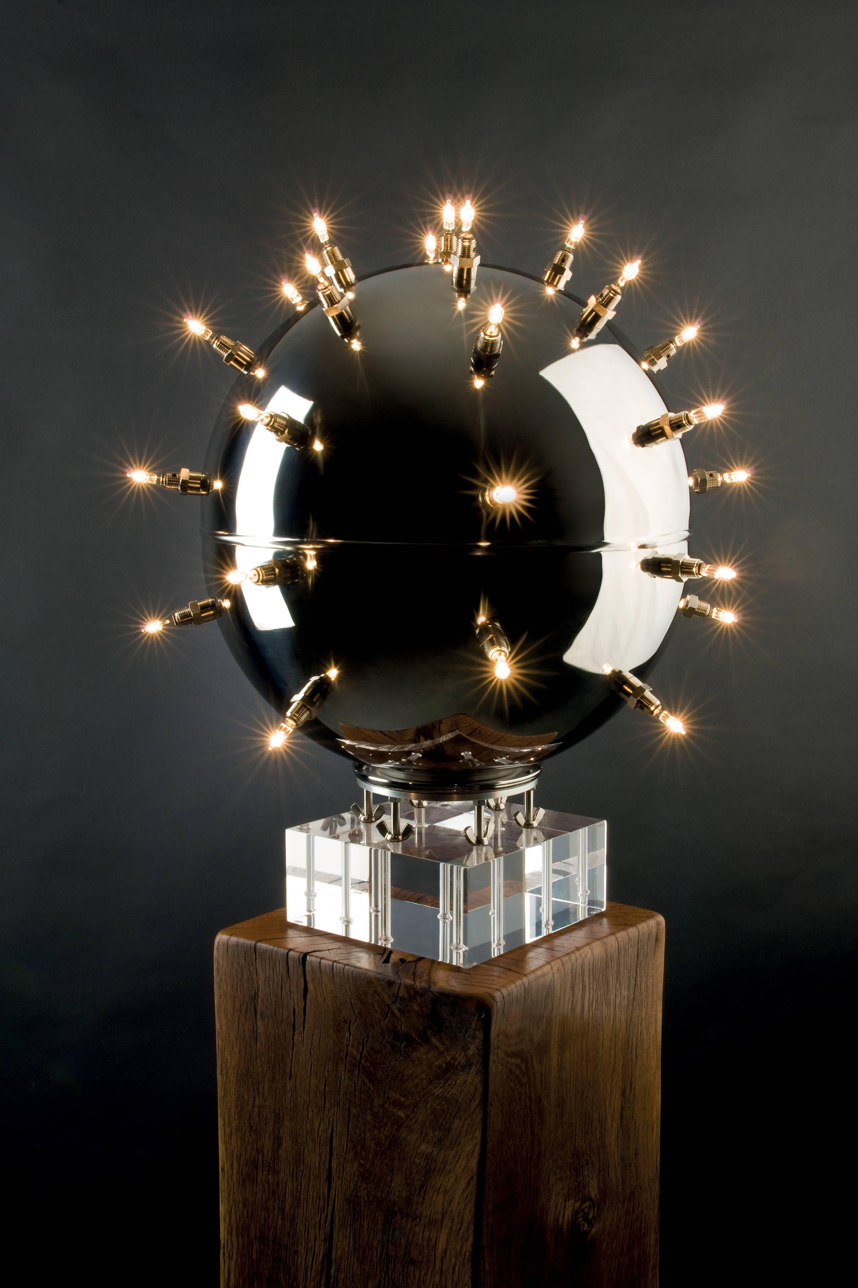 The table lamp 'BeMine 33' is composed of a sphere in mirror polished stainless steel and 33 sources of illumination. The highly polished stainless steel allows interesting games of reflection on the surface of the sphere, this also appears when the