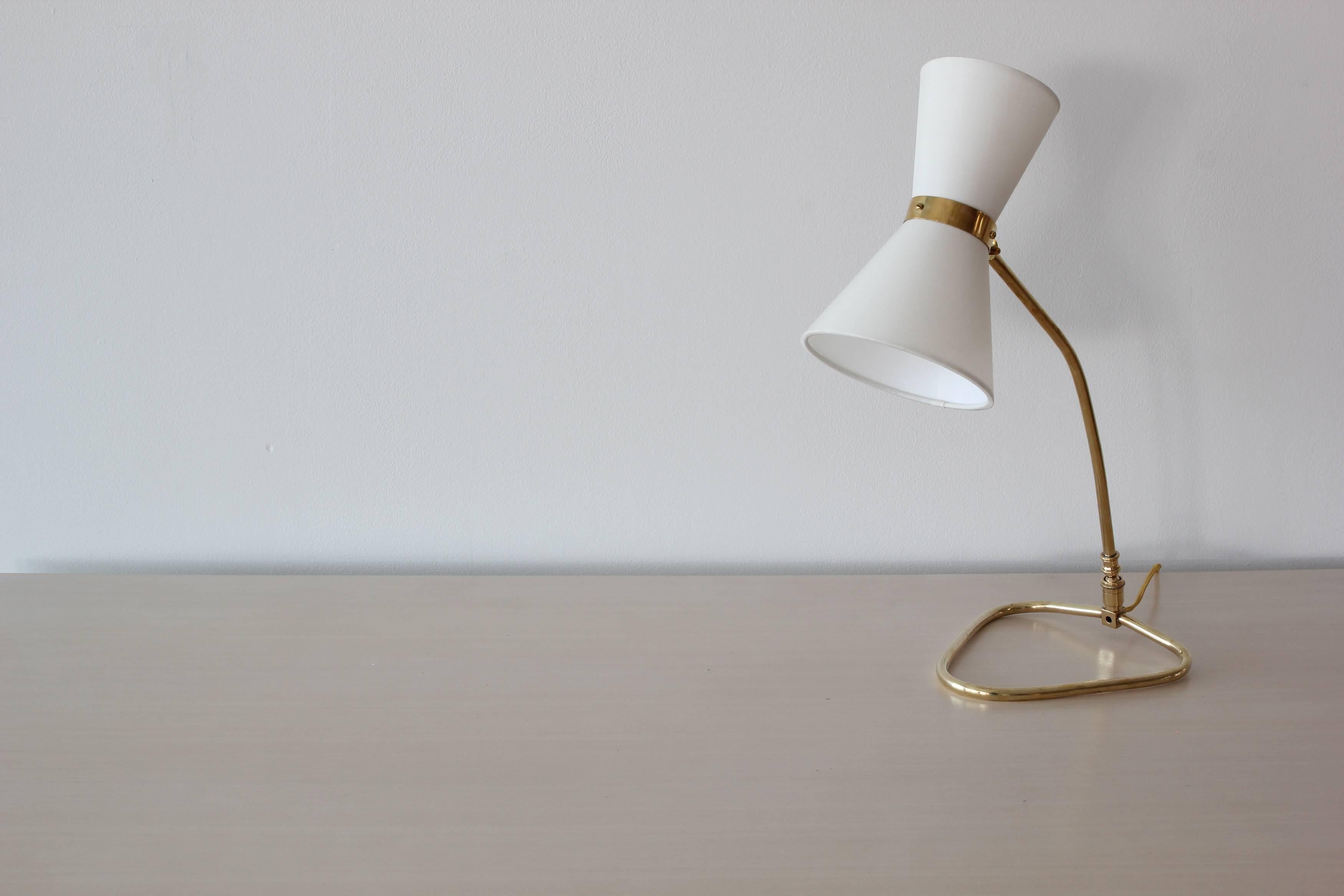 Wonderful table lamp in the style of Pierre Guariche with brass triangular base and new silk cone shades.
Newly rewired.