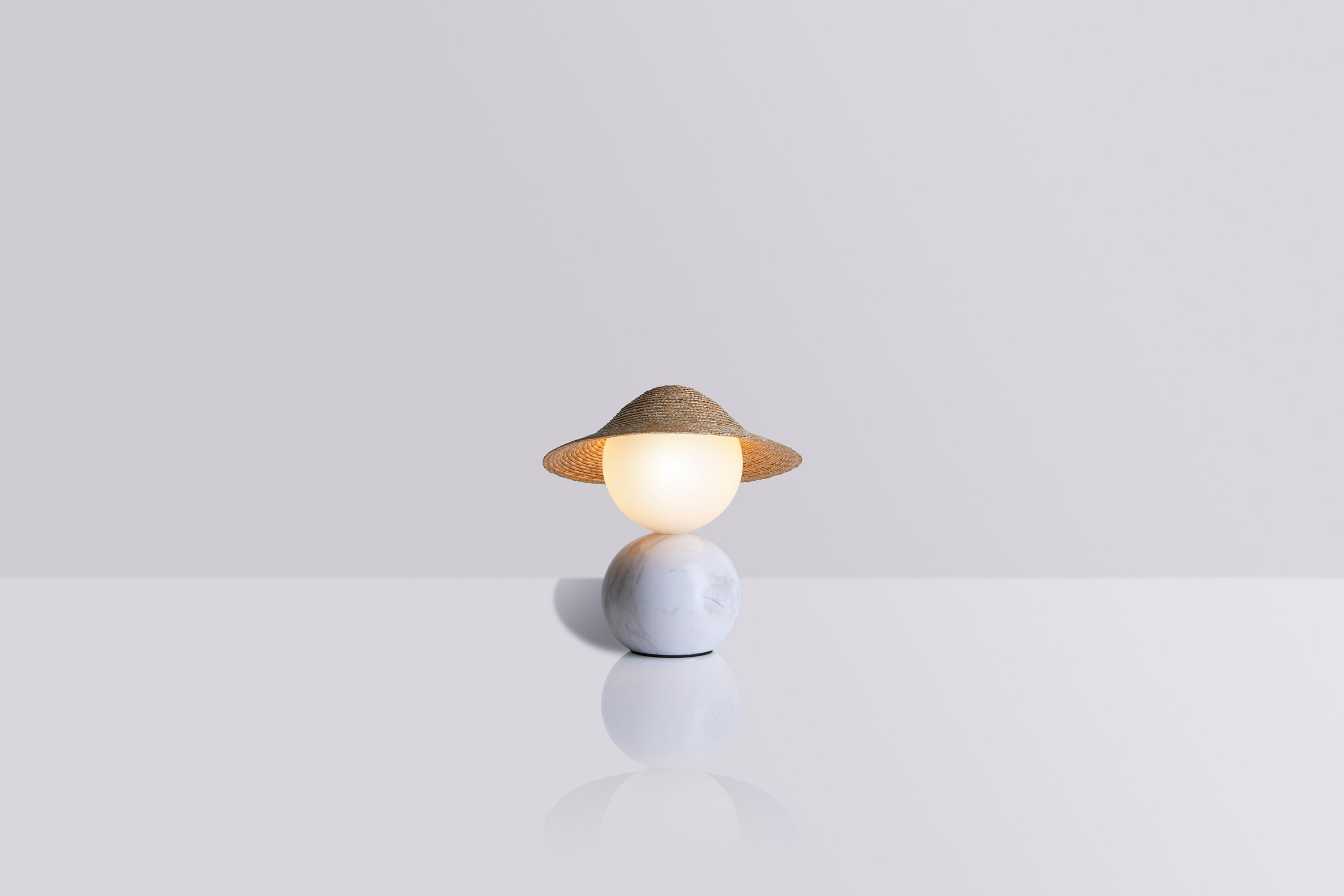 This version is the smallest member of the family and was created in 2022. It is characterised by its cute personality and the way the opaque glass head is balanced on its spherical body. As with every lighting object in Théros, it features a