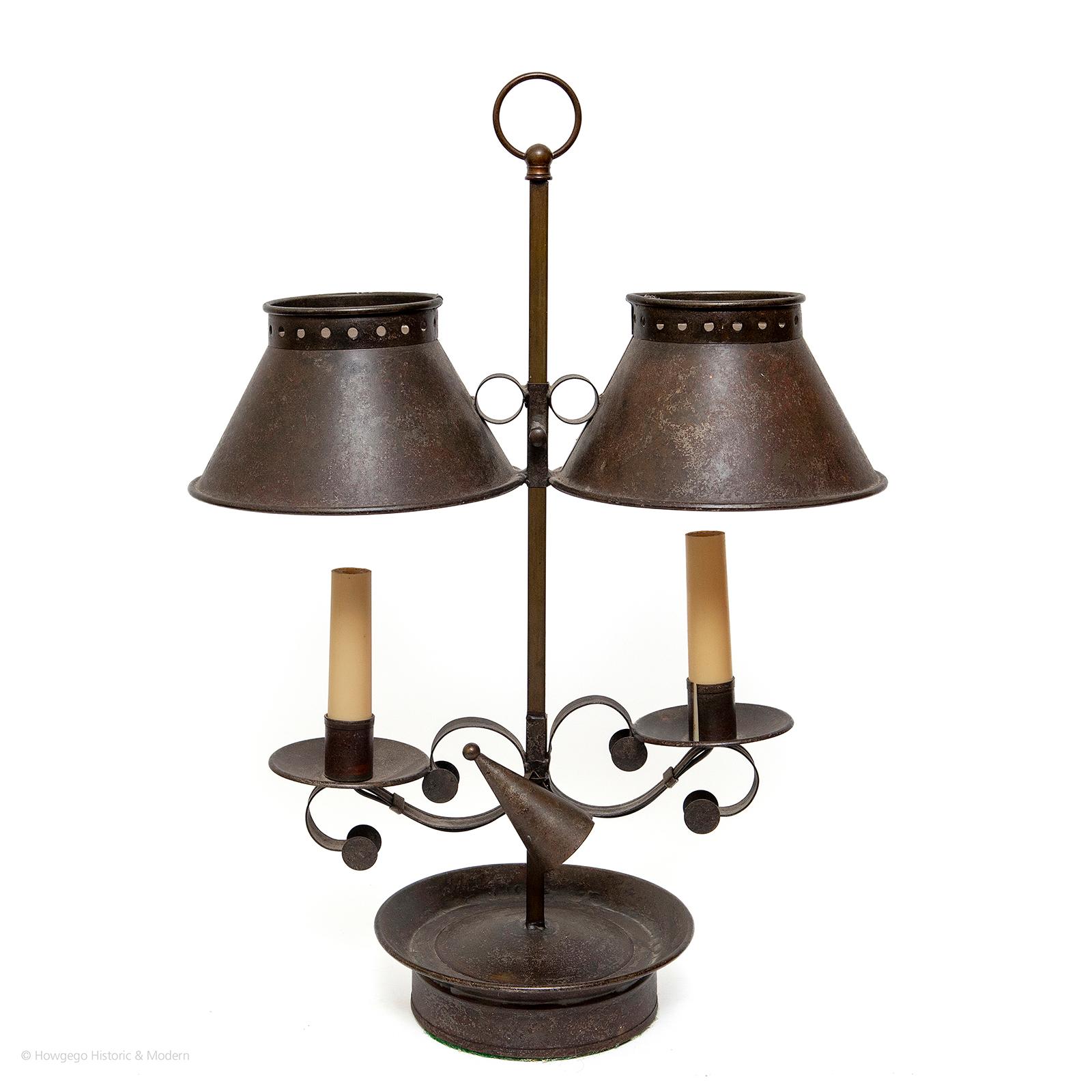 Surviving pieces of vernacular lighting are extremely rare and it is hard to source convincing re-creations. These are copies of a period fitting from xx and have a plausible antiqued patina.

Double candle tin table lamp with adjustable shades