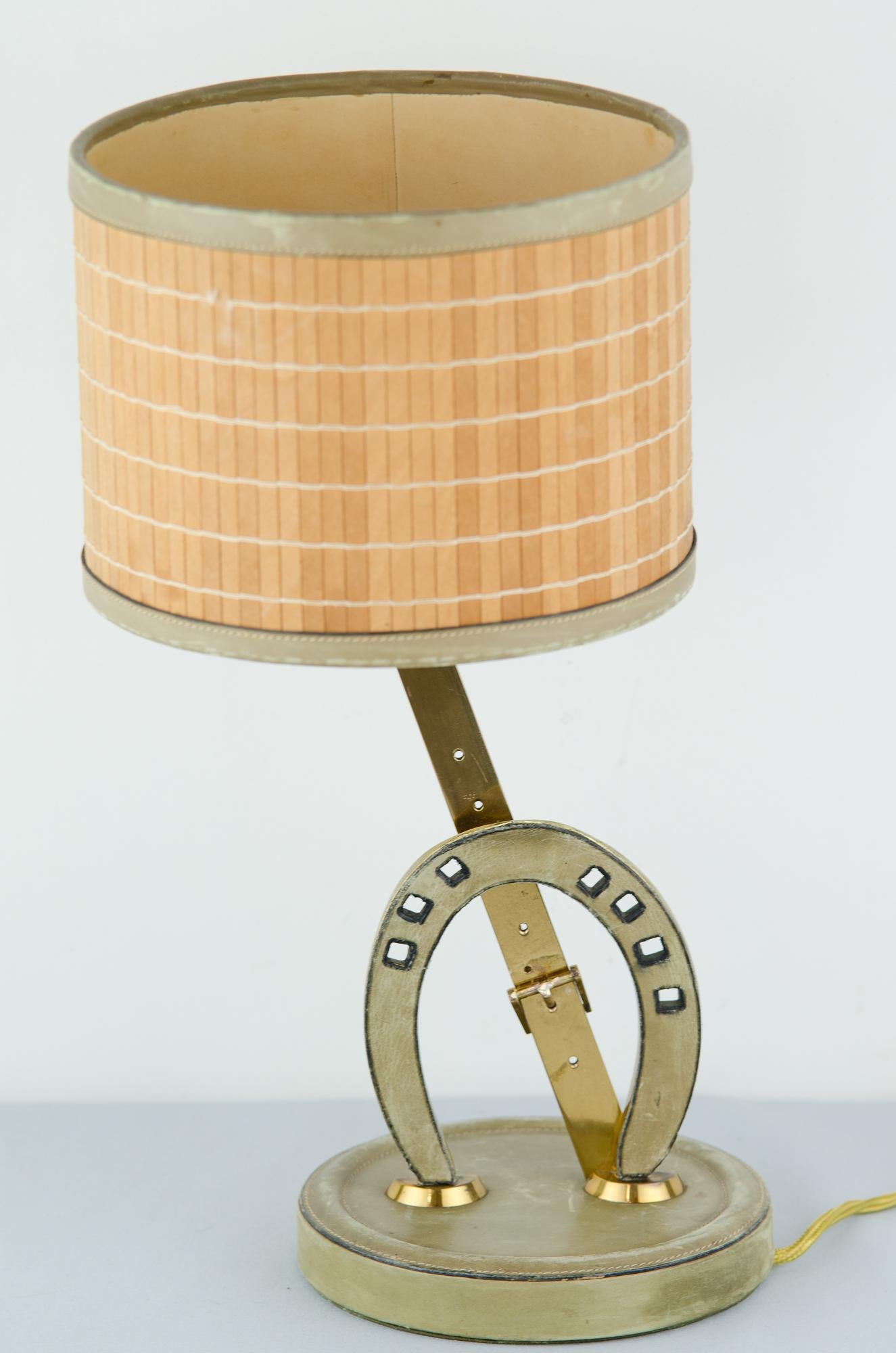 Table lamp, circa 1960s.
Brass and leather
Original shade
Original condition.