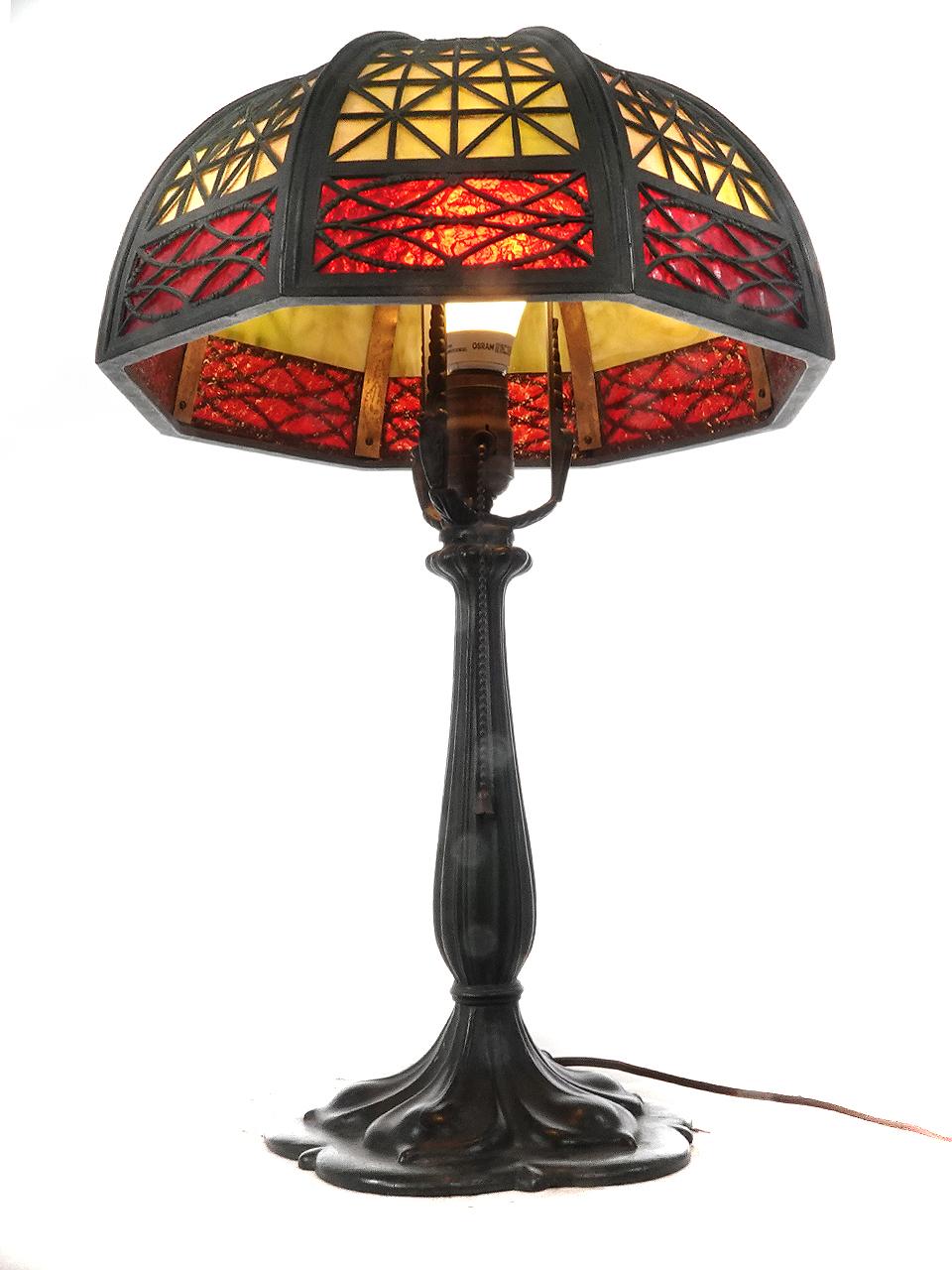 Arts and Crafts Table Lamp with Heavy Latticework Filigree and Red/Amber Glass For Sale
