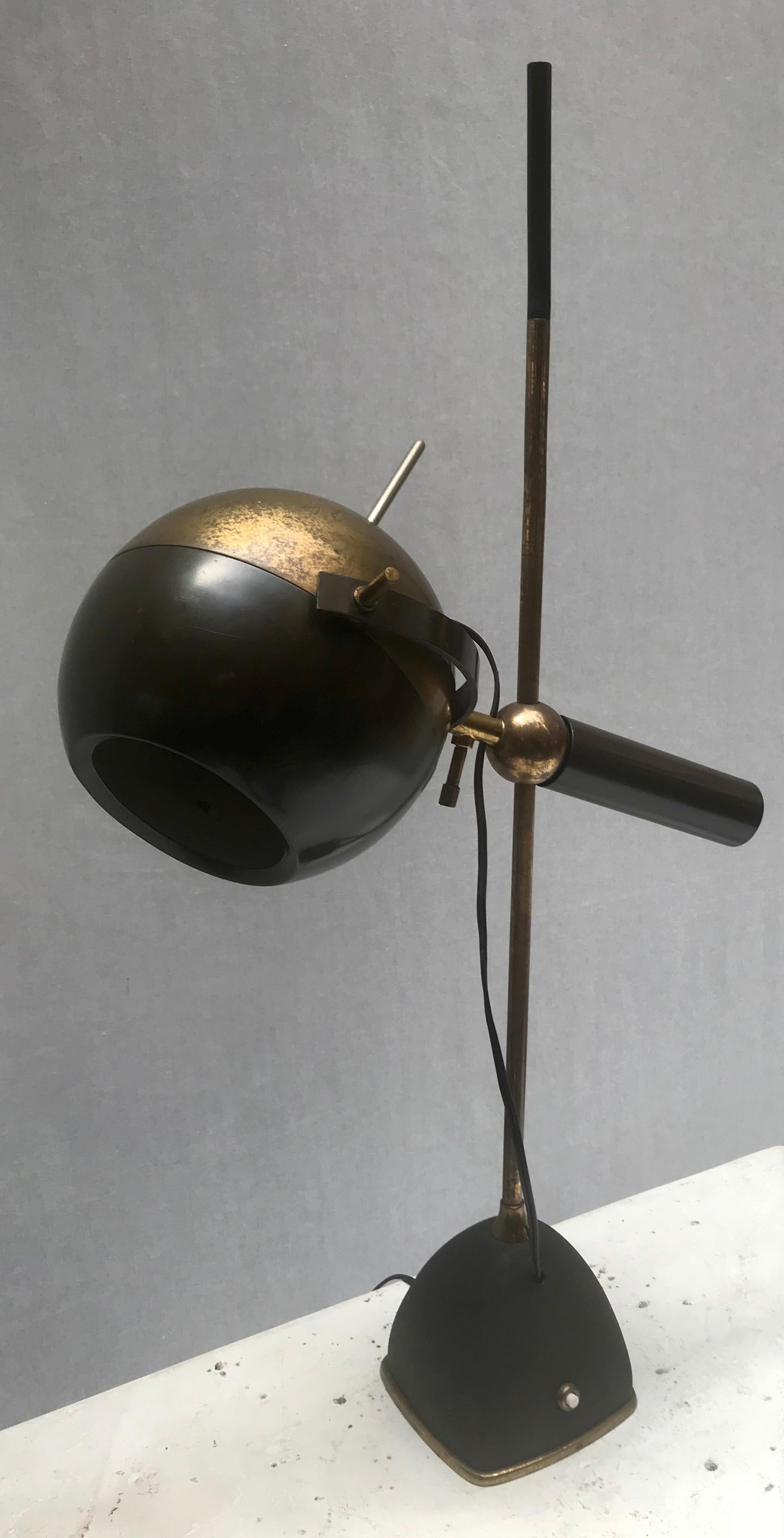 A rare table lamp by Oscar Torlasco for Lumi, Italy, 1950s.

Brass, tubular brass, painted brass, painted metal.

Rim of base impressed with 