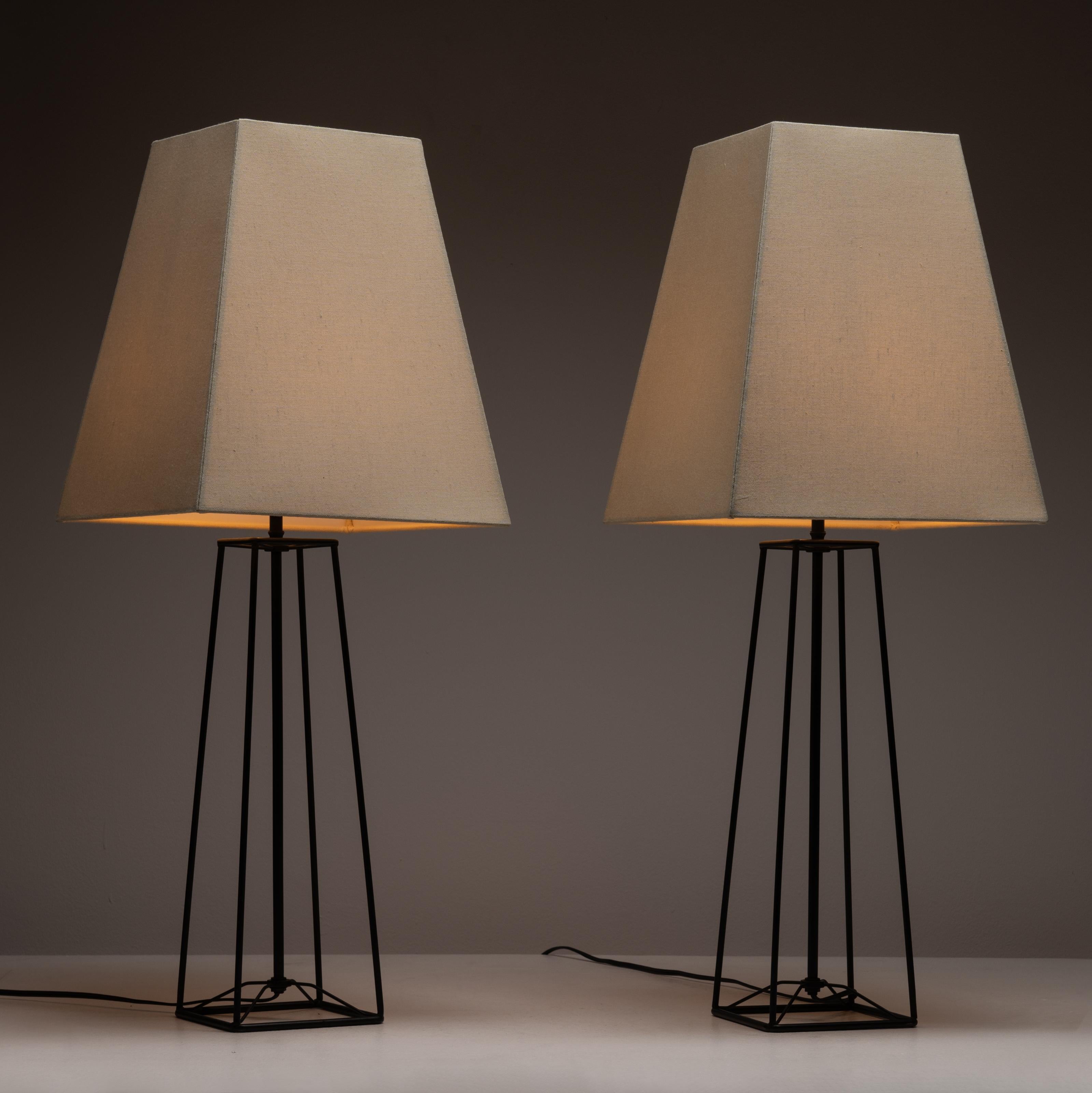 Table lamps by Harry Lawenda for Kneedler-Fauchère. Open-body, geometric iron table lamps that strike a perfect balance between minimal and industrial. New boxy linen shades have been fabricated for the pair. The table lamps each hold one E27 bulb