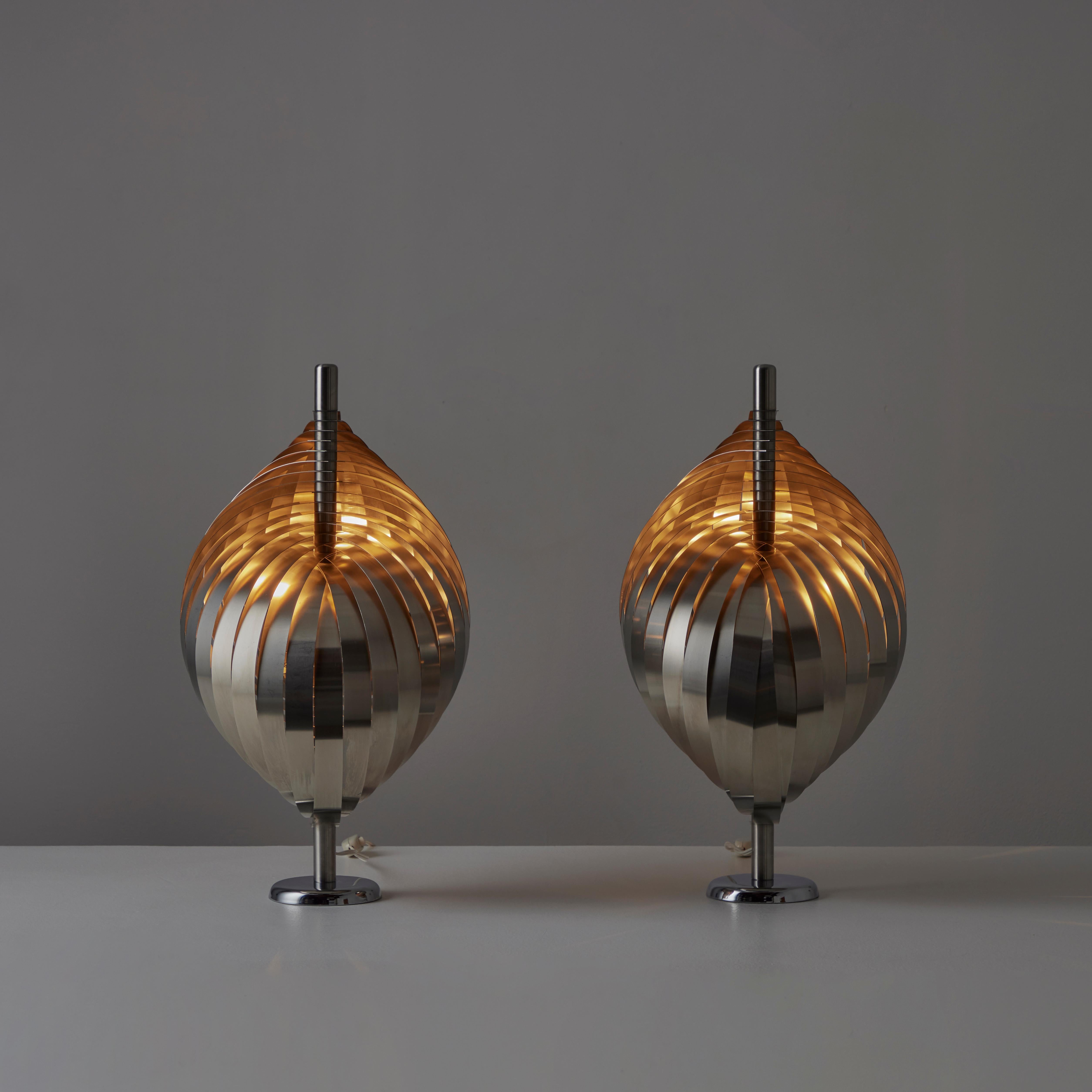 Pair of Table Lamps by Henri Mathieu. Designed and manufactured in France, circa the 1970s. Stainless steel metal ribbons spiral down a center table stem to form a striking and mysterious table. Each lap holds an E27 socket type, adapted for the US.