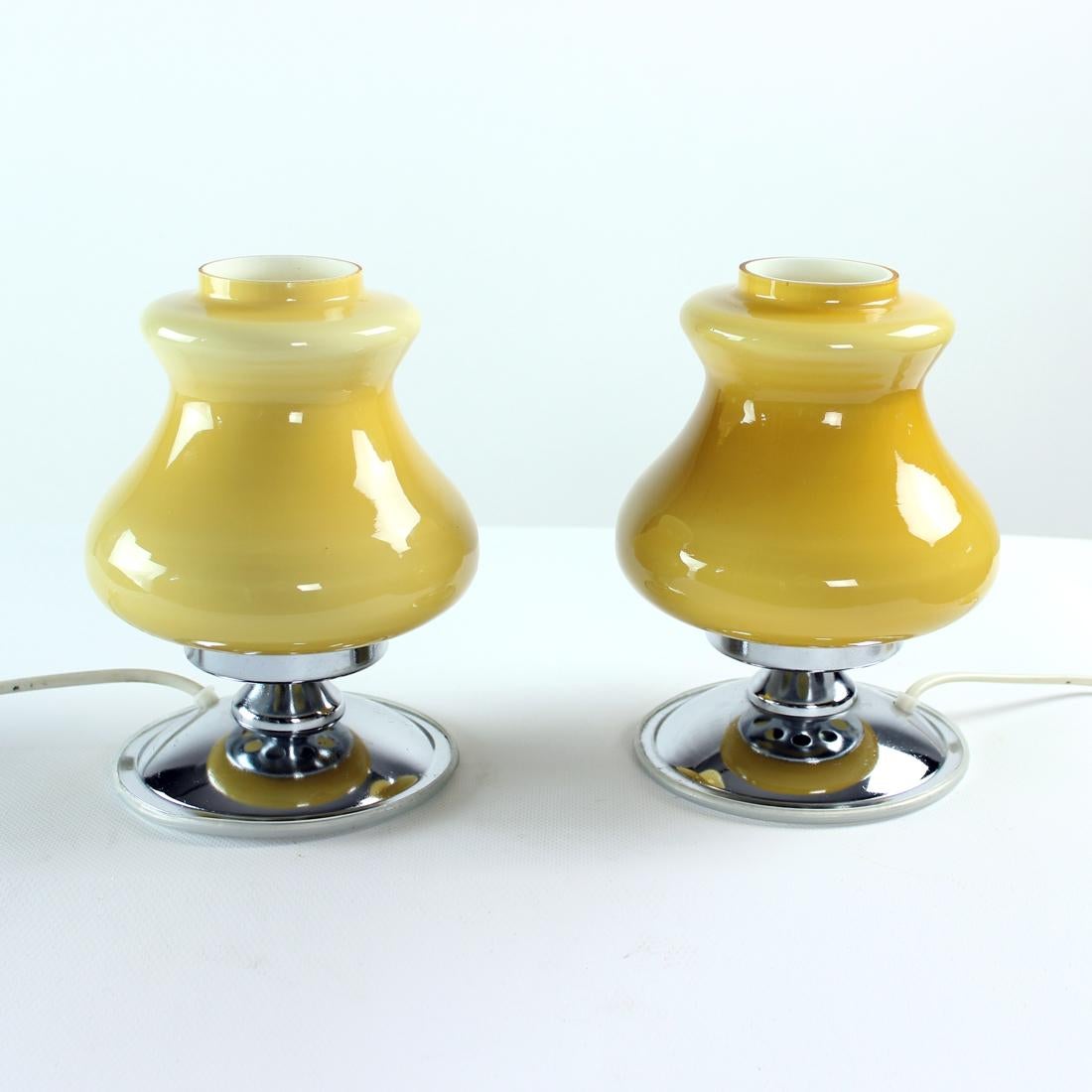 Set of two beautiful table lamps from mid-century design era. The lamps are produced in Bulgaria by Kamasit company. The finish is really lovely. Each lamp has a chrome metal base with a bottom lid in plastic (to protect furniture from scratching).