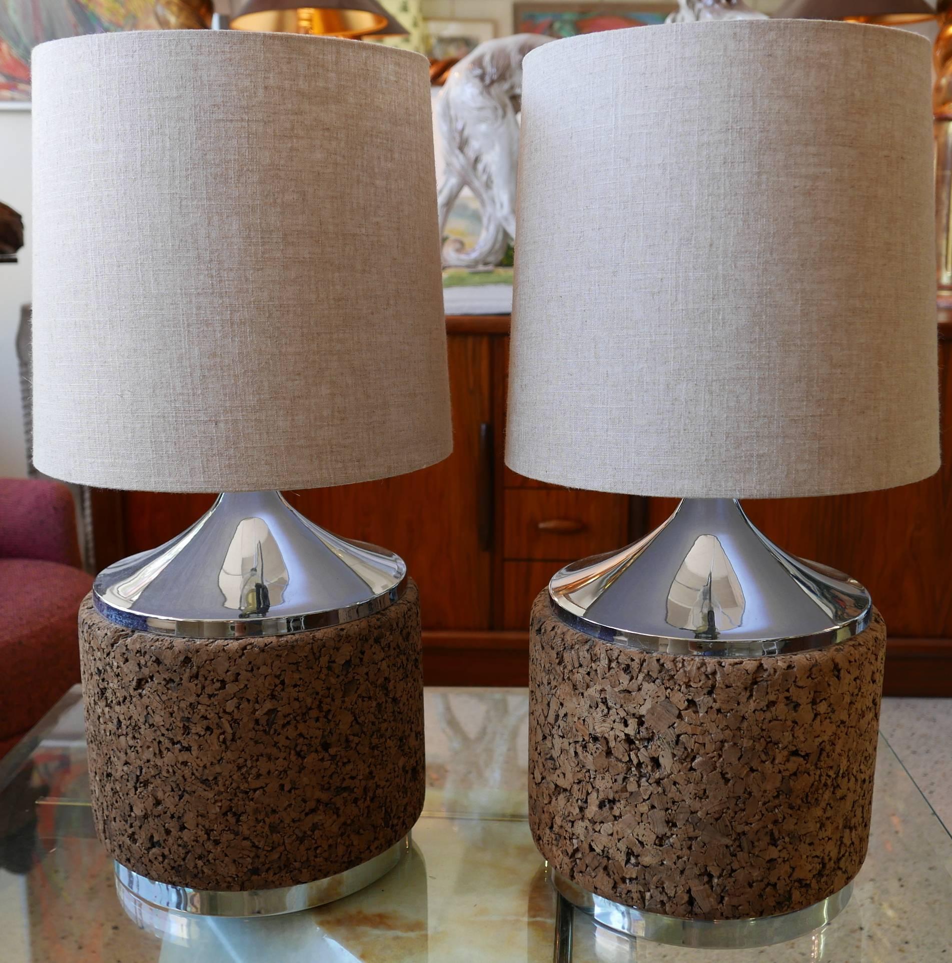 Table lamps (pair) of cork drum with chrome base and top, circa 1970. Original wiring has been professionally inspected and found to be in perfect working condition. Shades included.