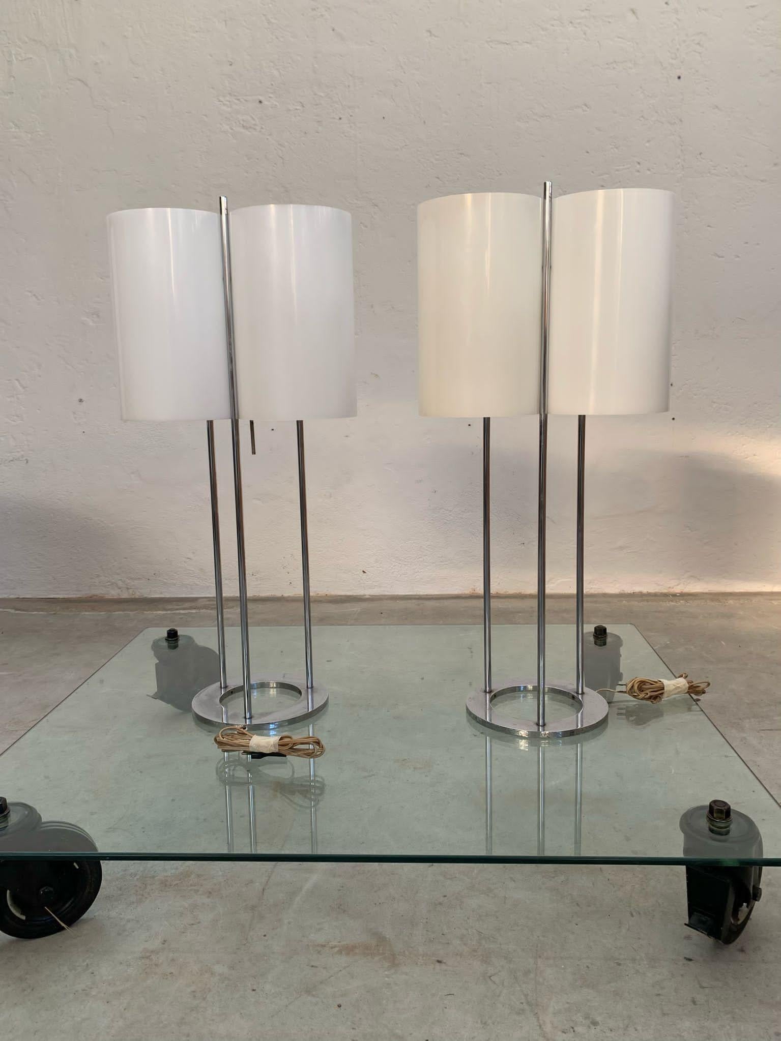 Pair of table lamps with chromed tubular and methacrylate by Paul Mayen for Habitat, 1960s

Each lamp has three standard bulbs with white cylinder shades and a chrome frame with a ring base.   
measures h89, width40 cm

