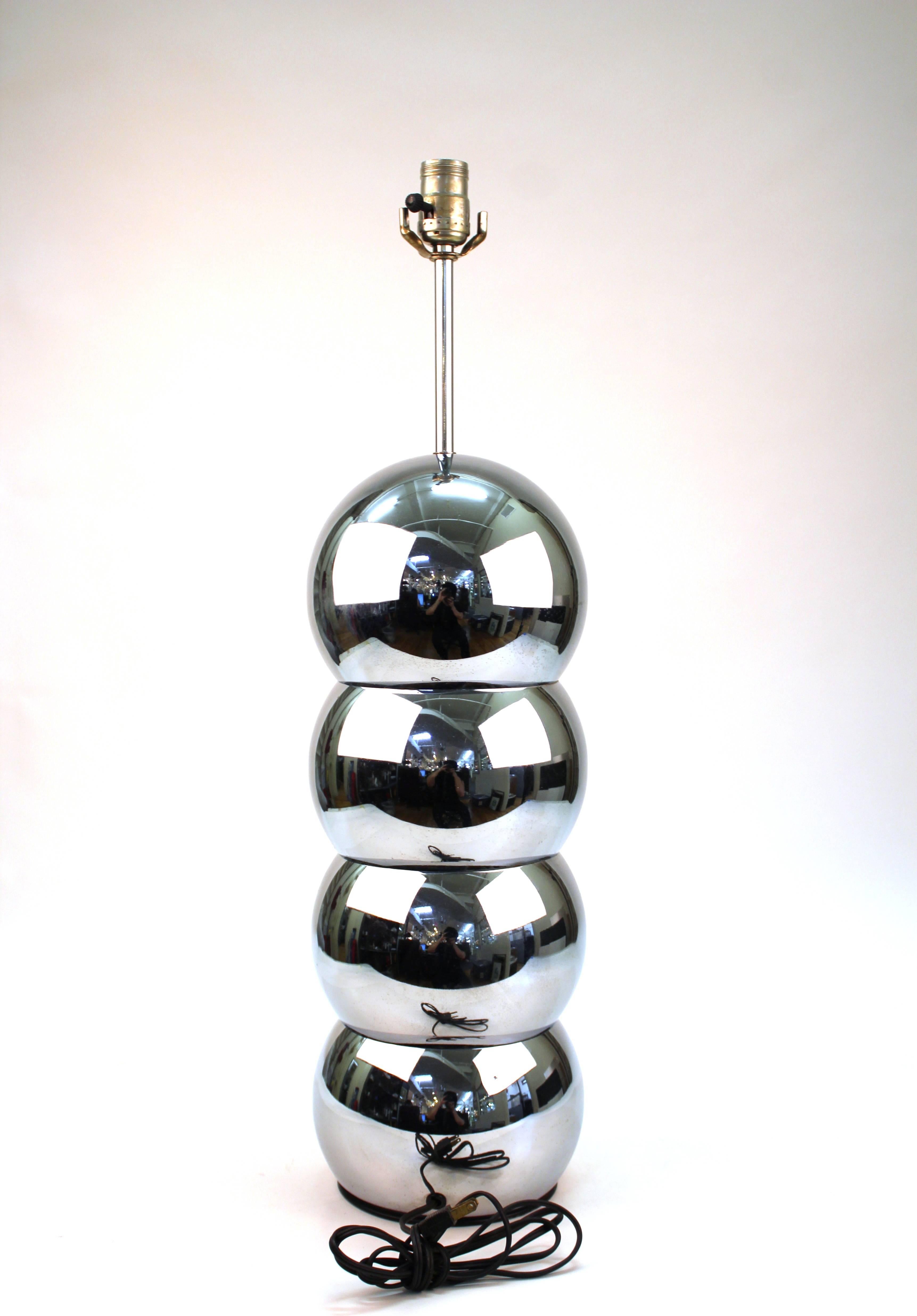 Table lamps in the form of four stacked spheres. Each has a high polished chrome finish. Wear appropriate to age and use with some scratches to finish. The lamps remain in good vintage condition.