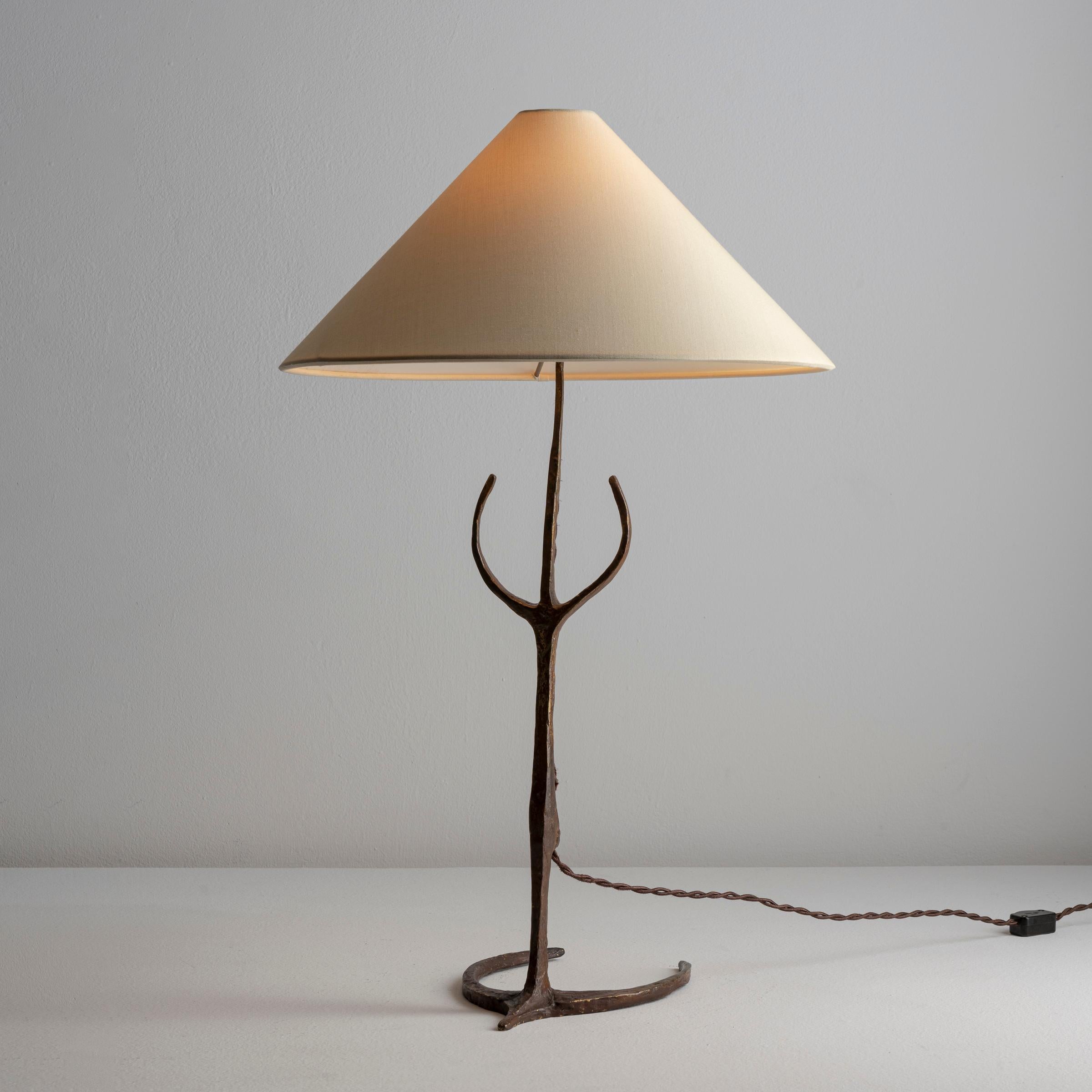 Table light by Felix Agostini. Designed and manufactured in France, circa 1960's. Sculpted bronze base, custom silk shade. We recommend one French bayonet 60w maximum bulb. Bulb not included. Rewired with brown French twist cord with dimmer switch.