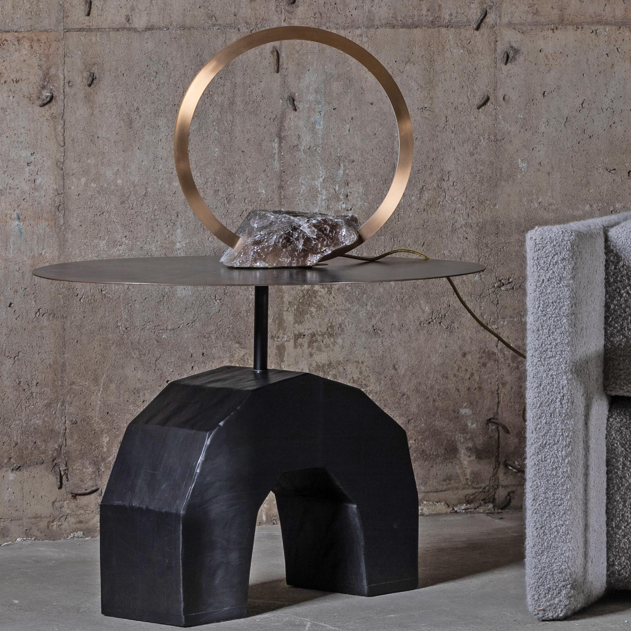 Contemporary table light sculpture in brass with quartz base, Portal 450 by Christopher Boots

Emanating luminescence from a minimalist form, Portal table lamp embodies the cyclical nature of existence.

Looking through Portal table lamp one is