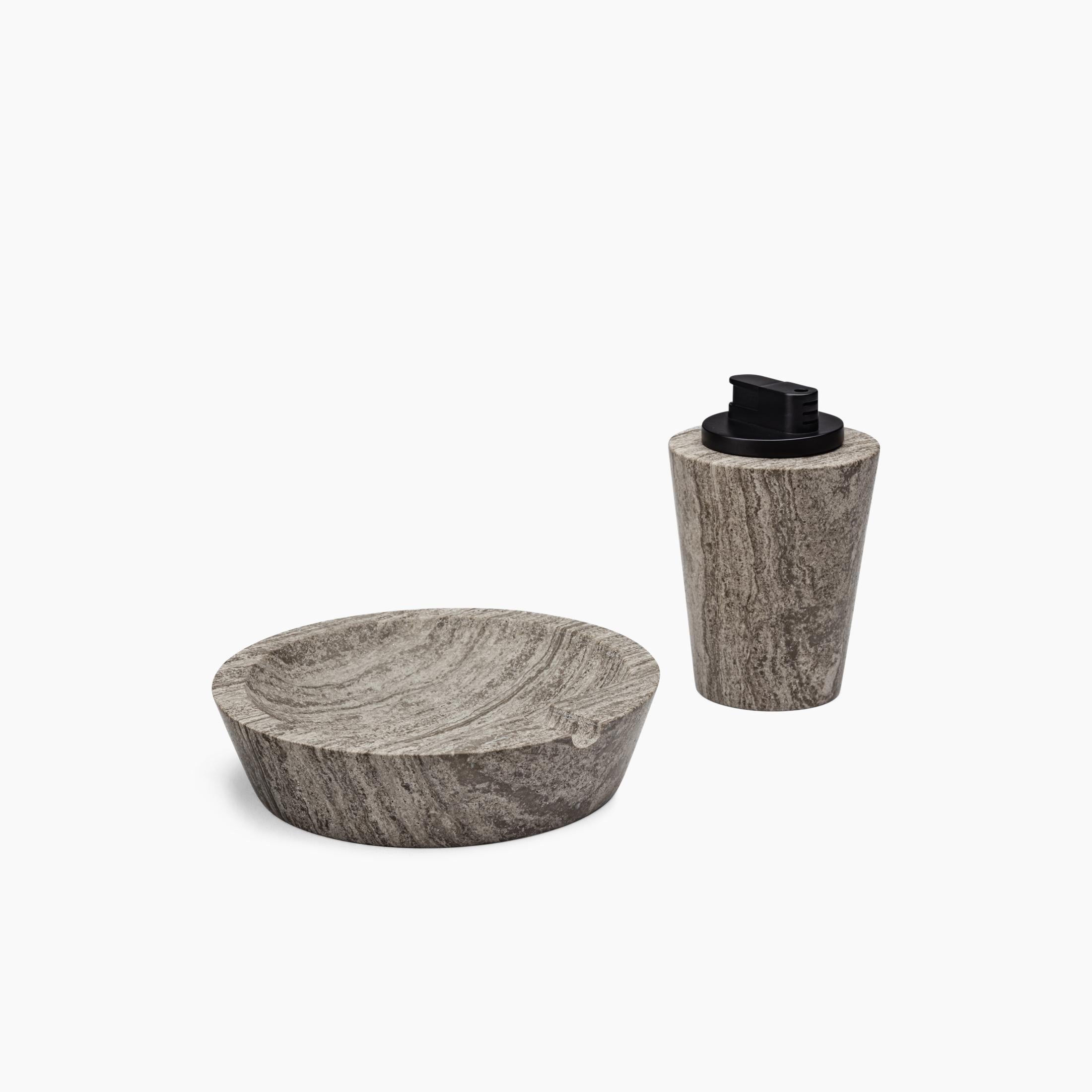 A table lighter machined from a solid block of stone and hand polished to a smooth honed finish. The removable lighter component is matte black and has an adjustable flame height and butane refill nossle on the bottom. Comes packaged in a branded