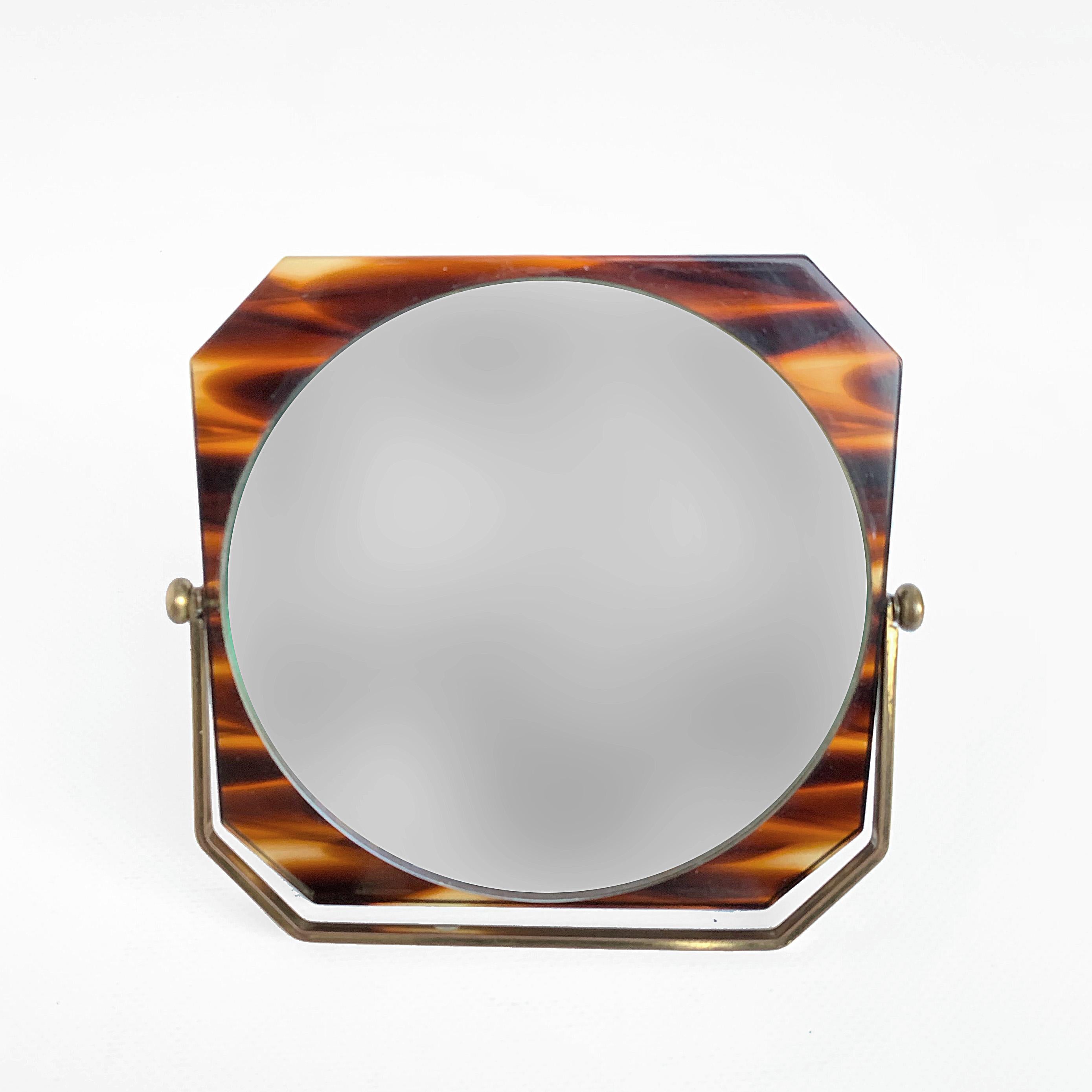 Table mirror in tortoise plexiglass. Italy 1970s, in the style of Christian Dior. Adjustable double-sided. One side of the mirror shows the signs of aging, the other is excellent.