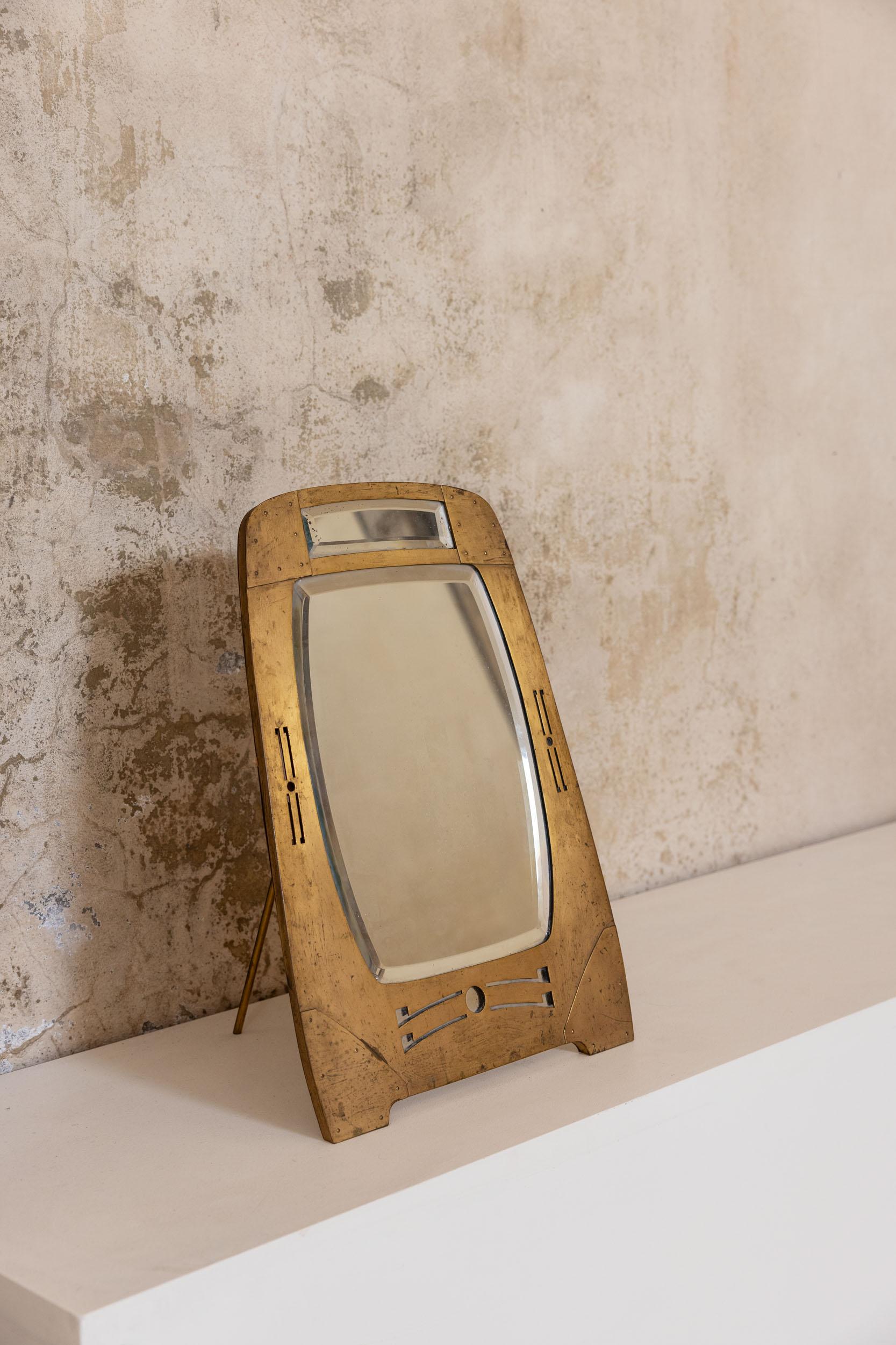 Art Nouveau table mirror crafted by Argentor of Vienna. The mirror is dating back to the early 20th century. The piece features a beautifully designed brass frame in the distinctive Art Nouveau style, and the glass is original. Argentor-Werke Rust &