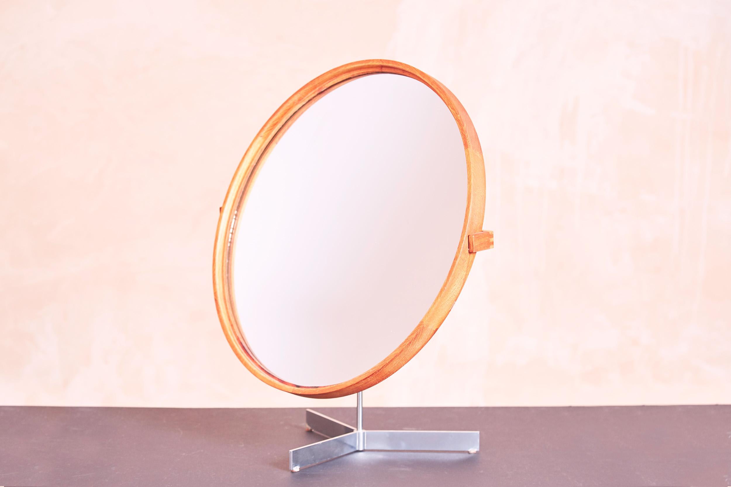 A table mirror by Luxus Vittsjö Sweden. 

1960s

The mirror is constructed with a teak frame and a metal tripod foot. The mirror is rotatable in all directions and can be swivelled upwards.

Designed by the brothers Uno & Östen