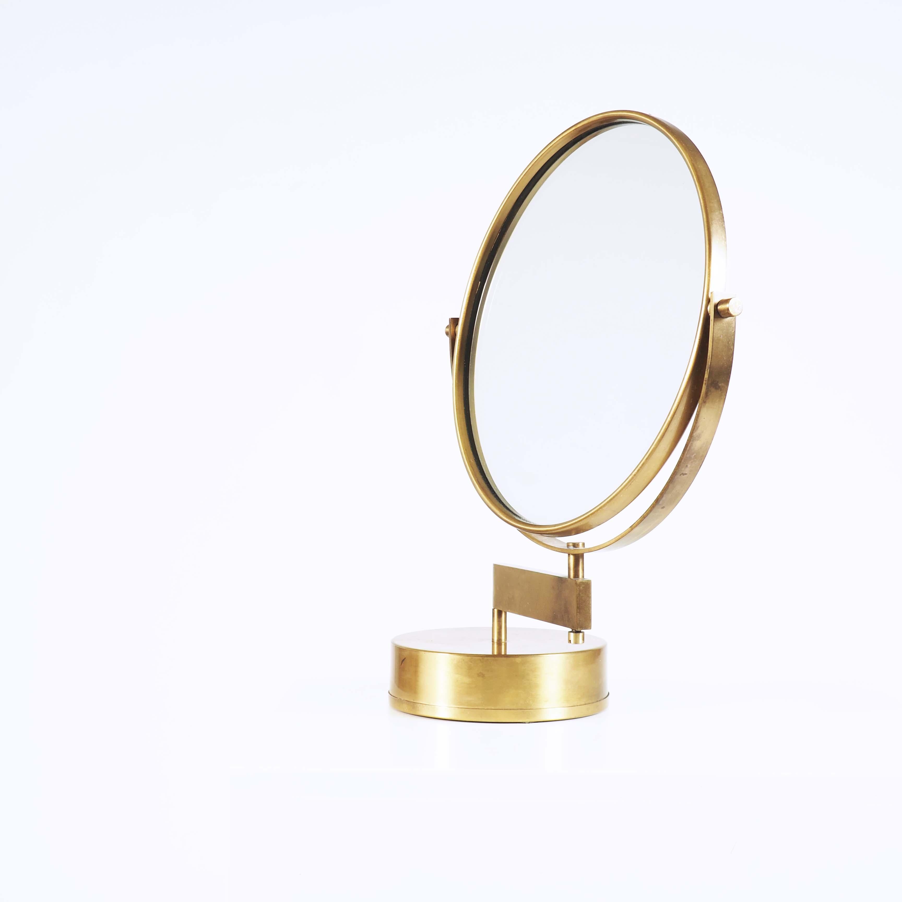 Table mirror in brass with an adjustable arm. Designed by Hans Agne Jakobsson and made at his own factory in Markaryd, Sweden.
A very heavy base makes it stabile.