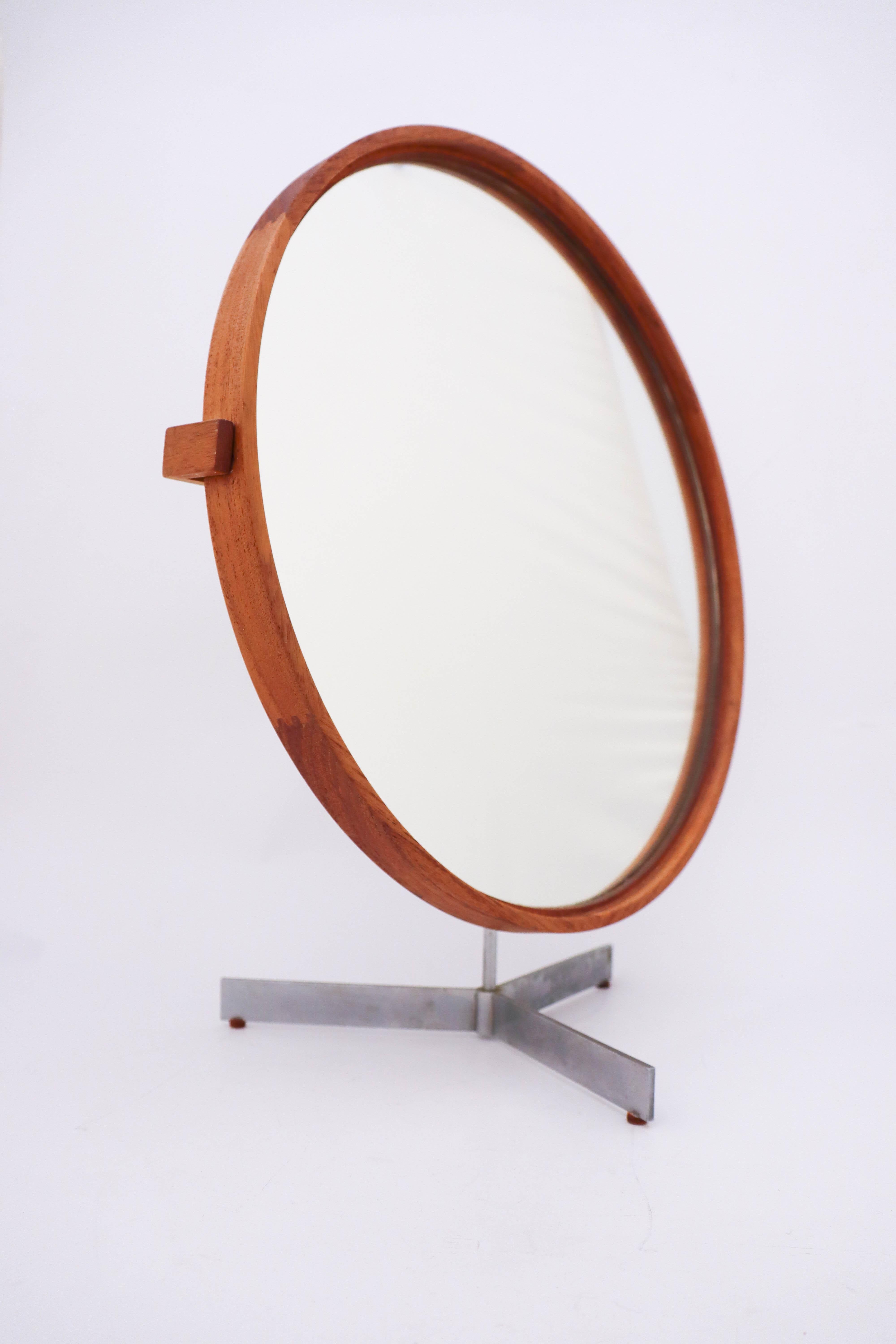 Rare table mirror designed by Uno & Östen Kristiansson. Produced by Luxus in Vittsjö, Sweden. Frame made from solid lime treated teak. Zipper joinery on the frame and the back piece. Base in brushed aluminum. It is adjustable in angle and swiveling.