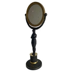 Tischspiegel mit Karyatid im französischen Empire-Stil. Vergoldete und dunkle patinierte Bronze