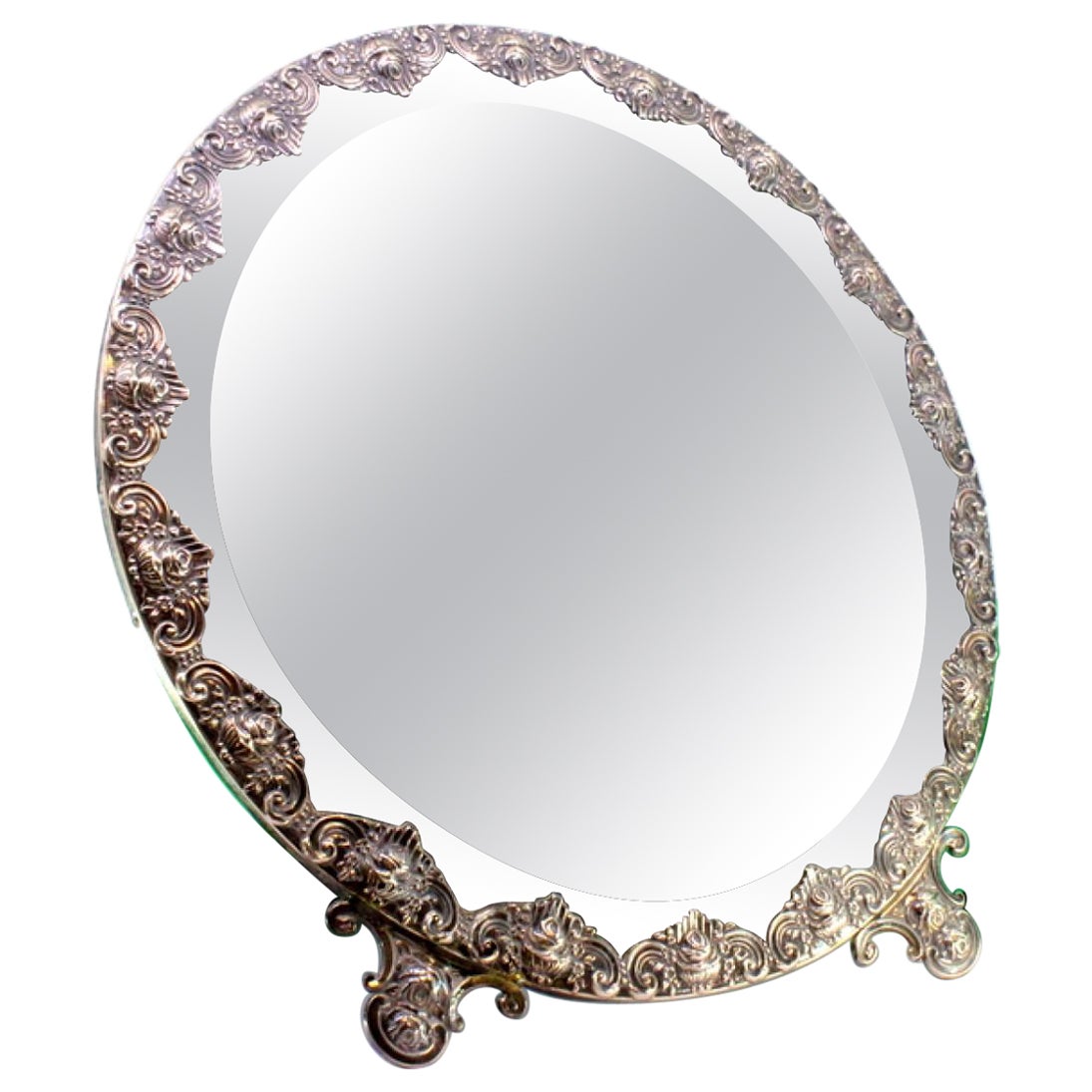 Table mirror with silver applications on wood and resting on two cut-out feet