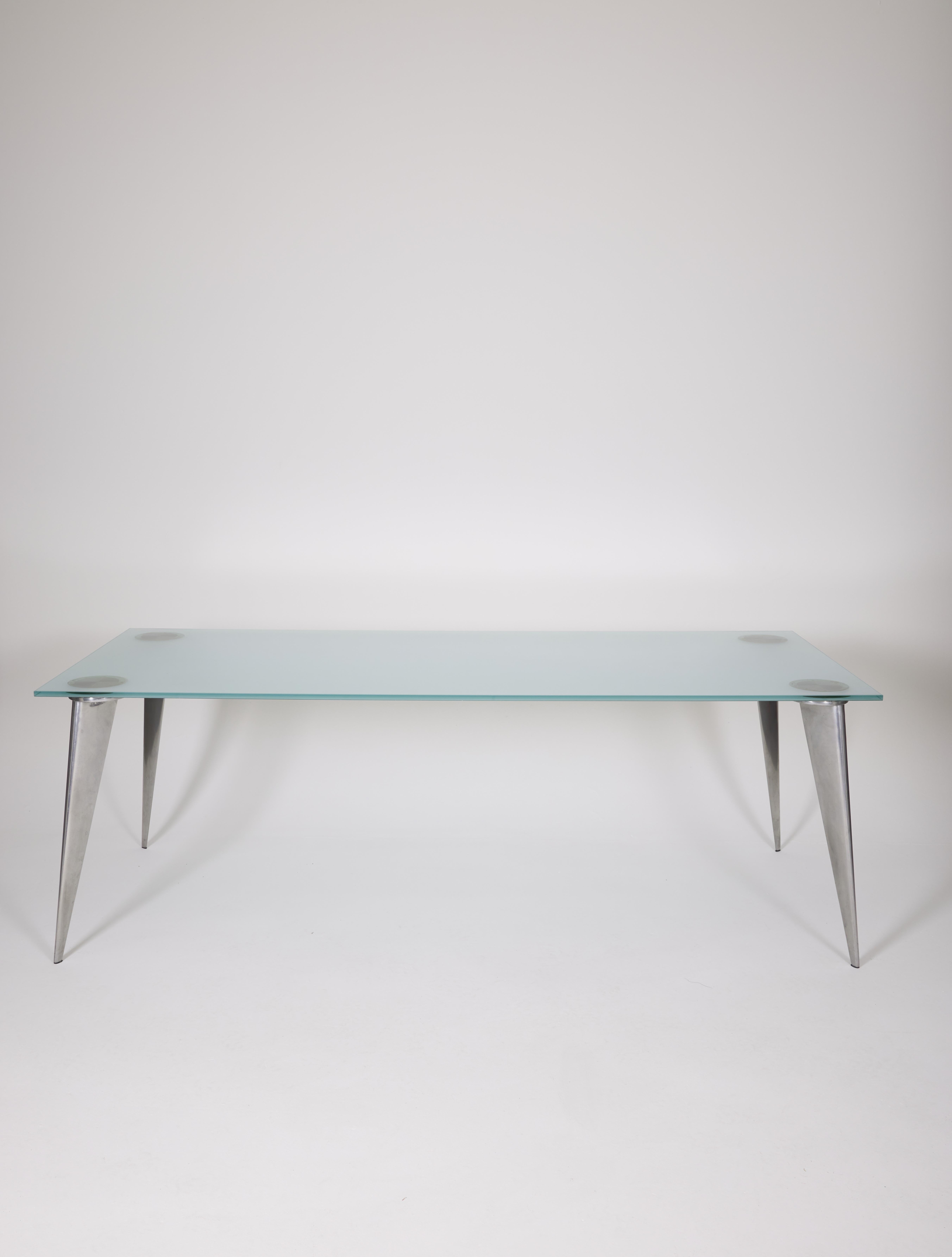 Dining table model J. Lang series by Phillippe Starck for Driade, 1991. Sandblasted glass top and cast aluminum base. Good condition with some traces of use.