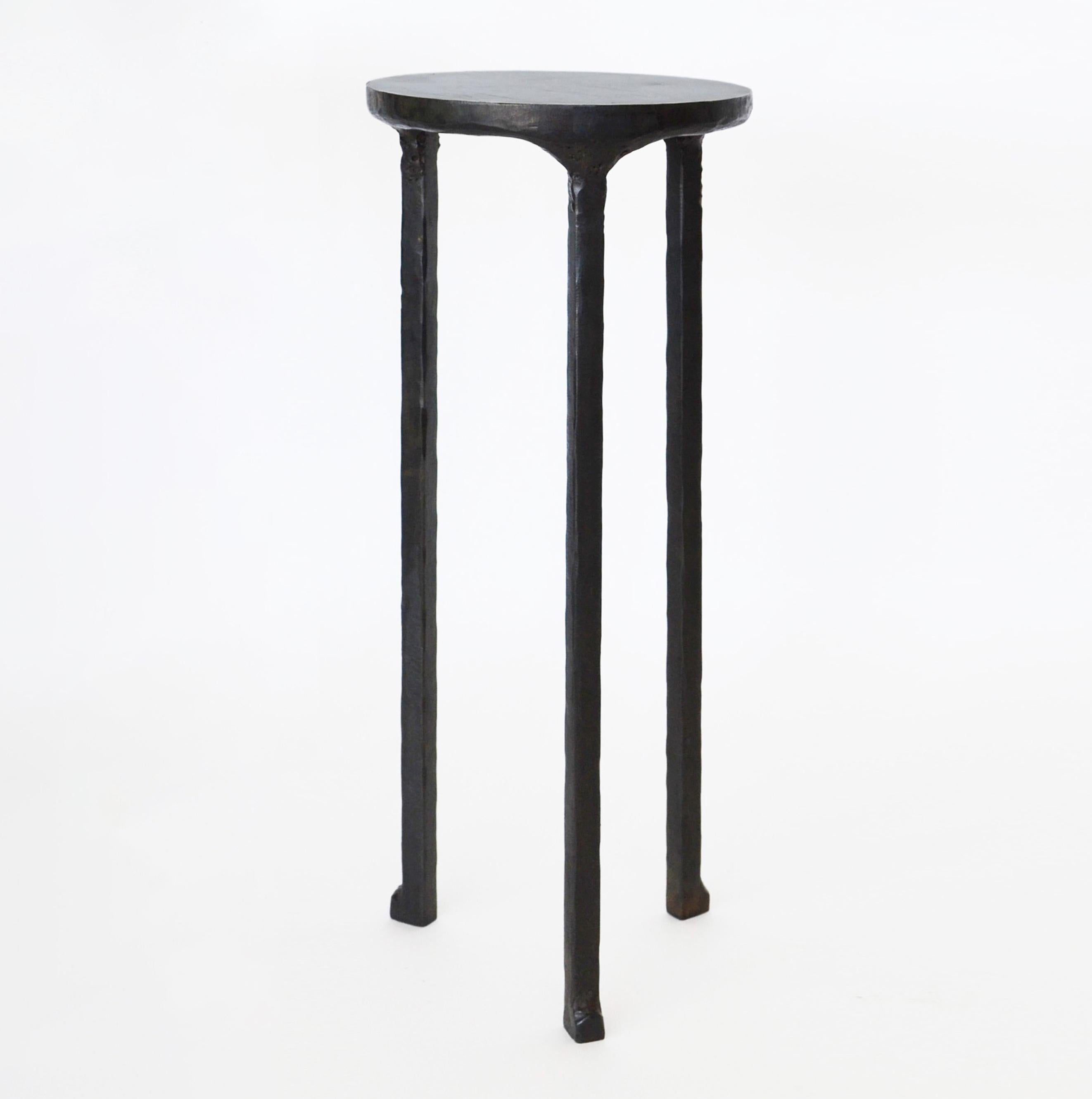 Table No. 3 small by JM Szymanski
Dimensions: L 8” x W 8” x H 20”
Materials: Blackened waxed steel

The perfect side table! A sculpted bottom frame supports a smooth top surface that is ideal for drinks and small items. The small size makes this