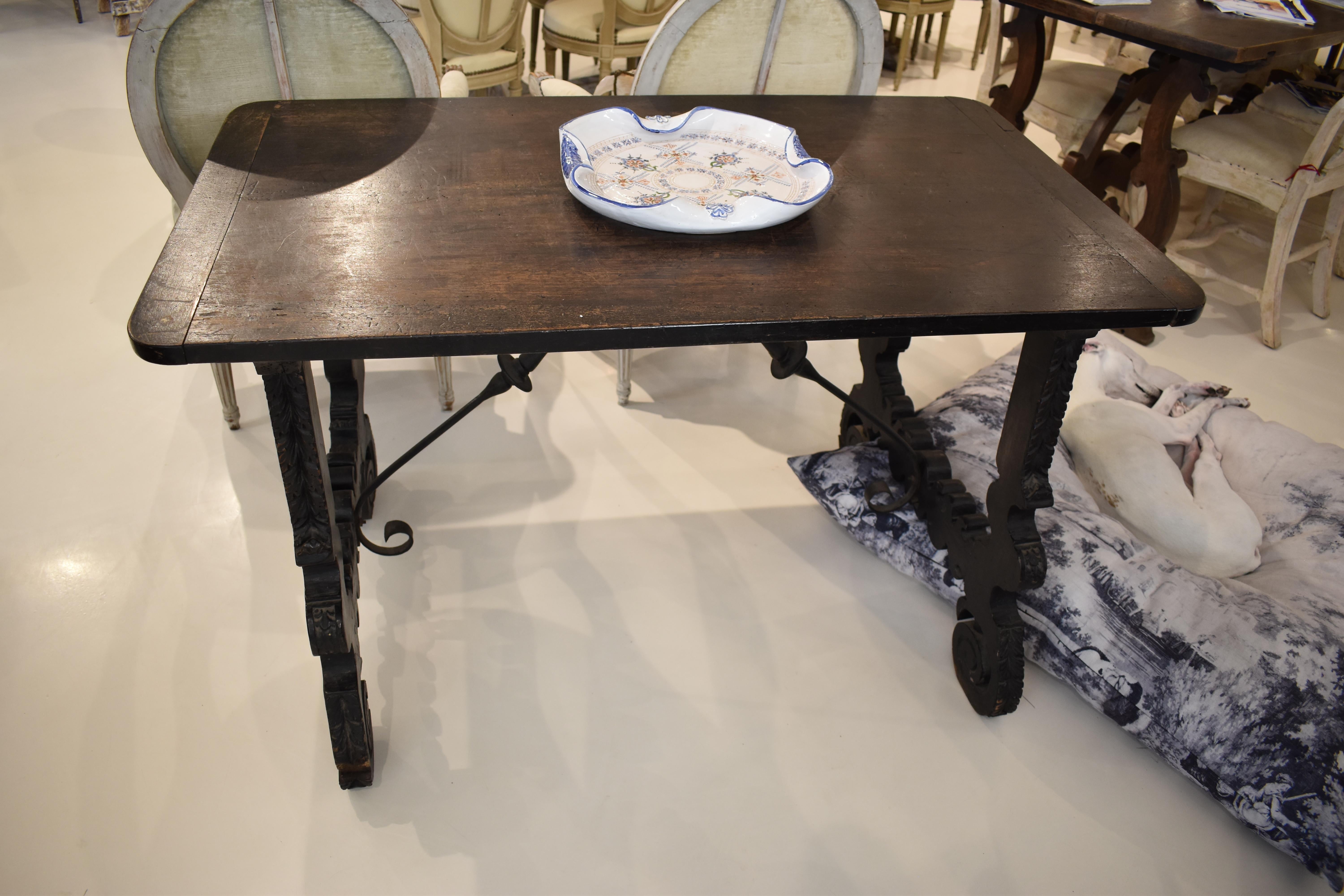 18th Century Noir Spanish Table with wrought ironwork braces in a cross-bar design.