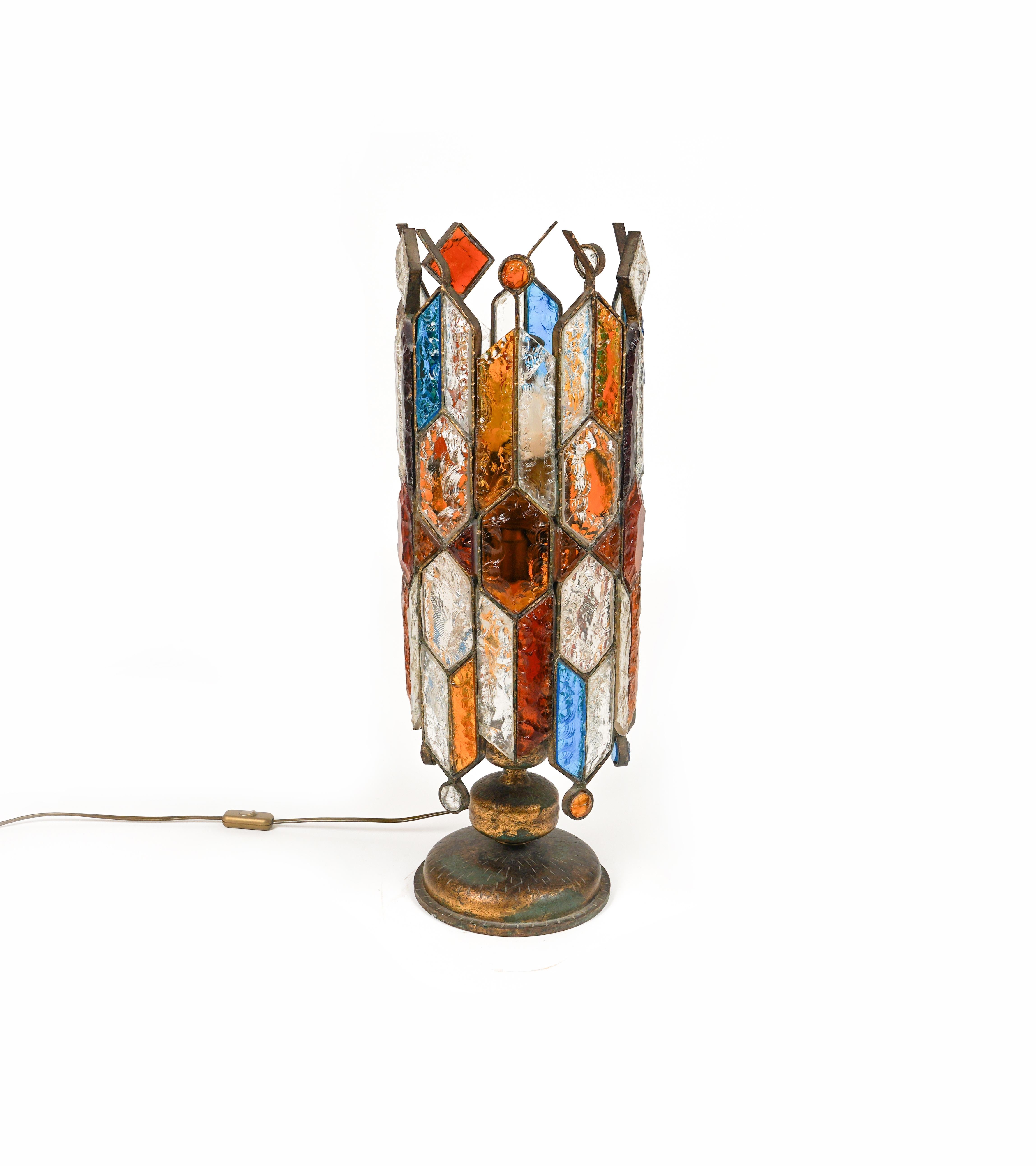 Amazing big Midcentury table lamp or floor lamp in golden wrought iron and multi-color hammered glass produced by Longobard the concurrent of Poliarte at the 1960s / 1970s.   

Made in Italy in the 1970s.  

It uses 10 bulbs.

The color of the
