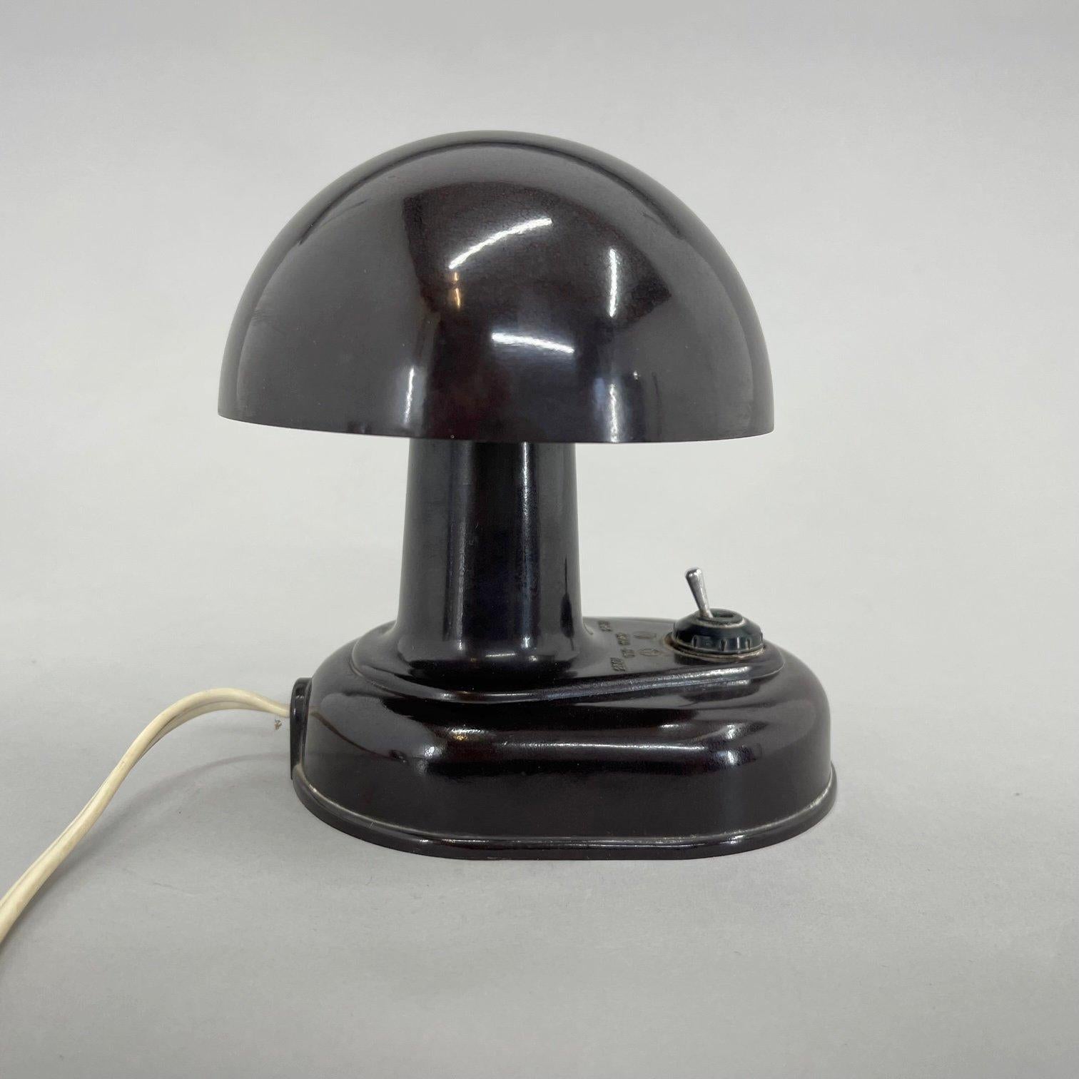 Little table or wall bakelite lamp from Czechoslovakia. The lamp is usually used as a table lamp, but it can be hanged on the wall as well.