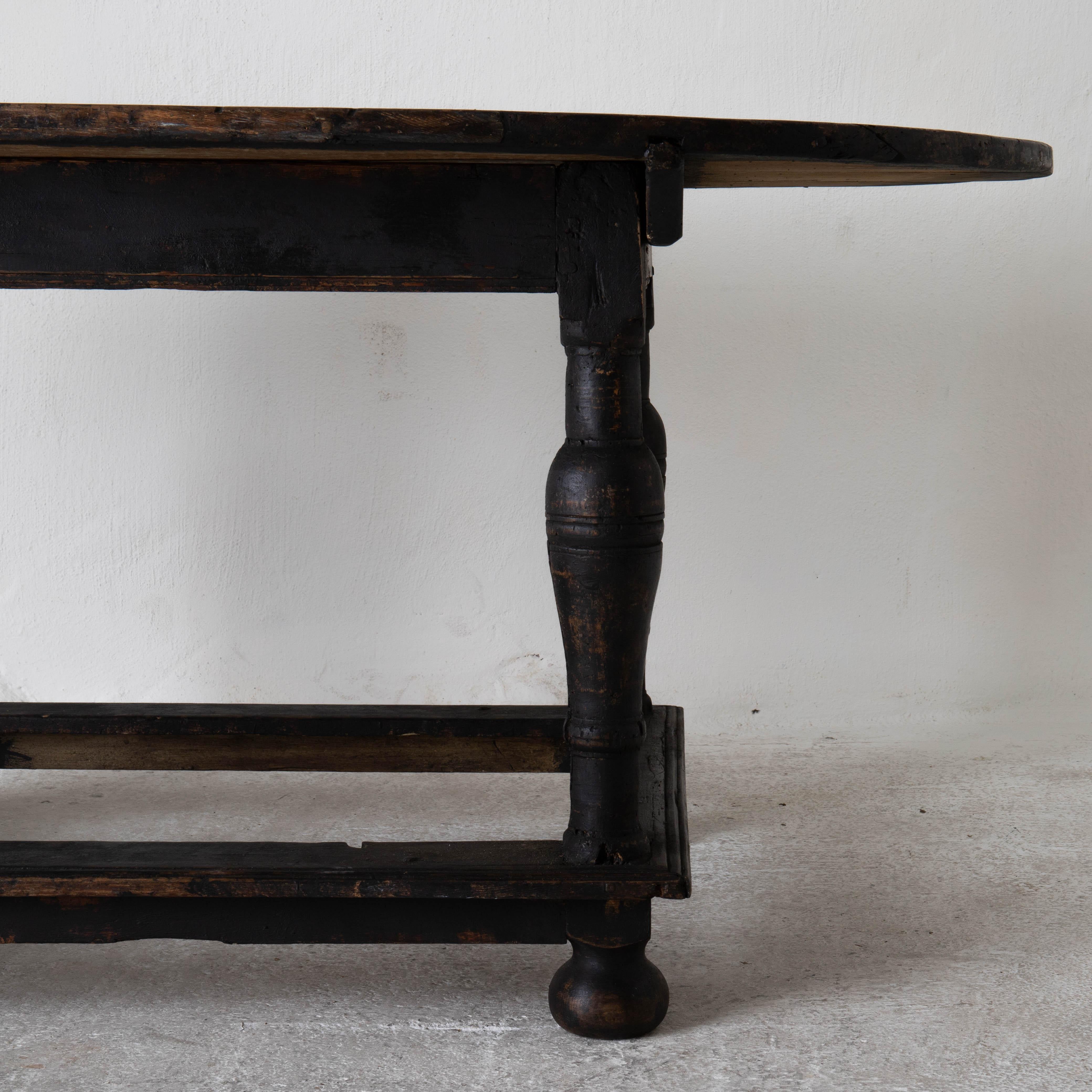 Table oval Swedish clack baroque 18th century Sweden. A library table made during the Baroque period in Sweden, 1650-1750. Repainted in our Laserow black. Oval top with a square base and rounded legs standing on ball feet. Perfect as a centre table